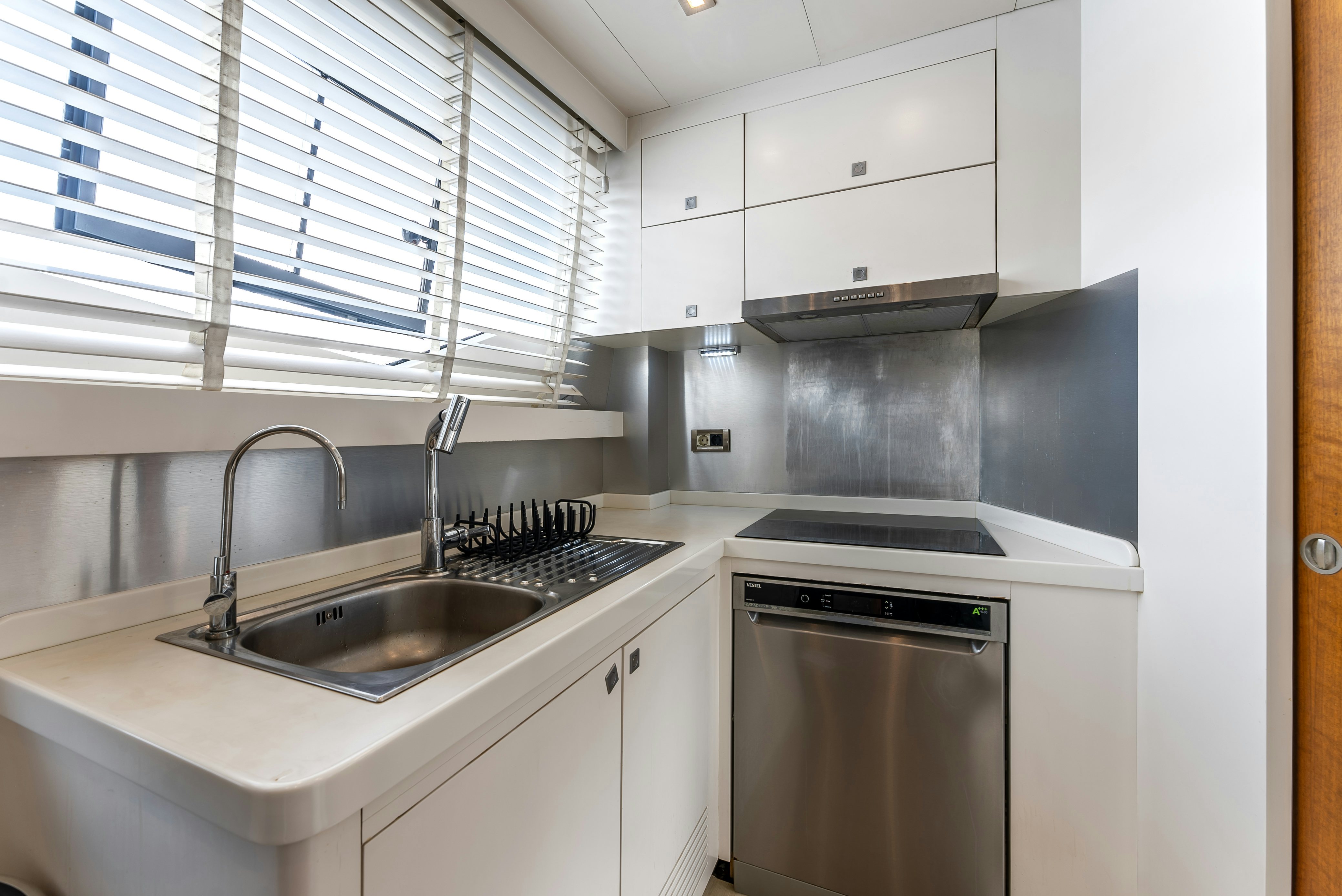 a kitchen with white cabinets aboard LADY F Yacht for Sale
