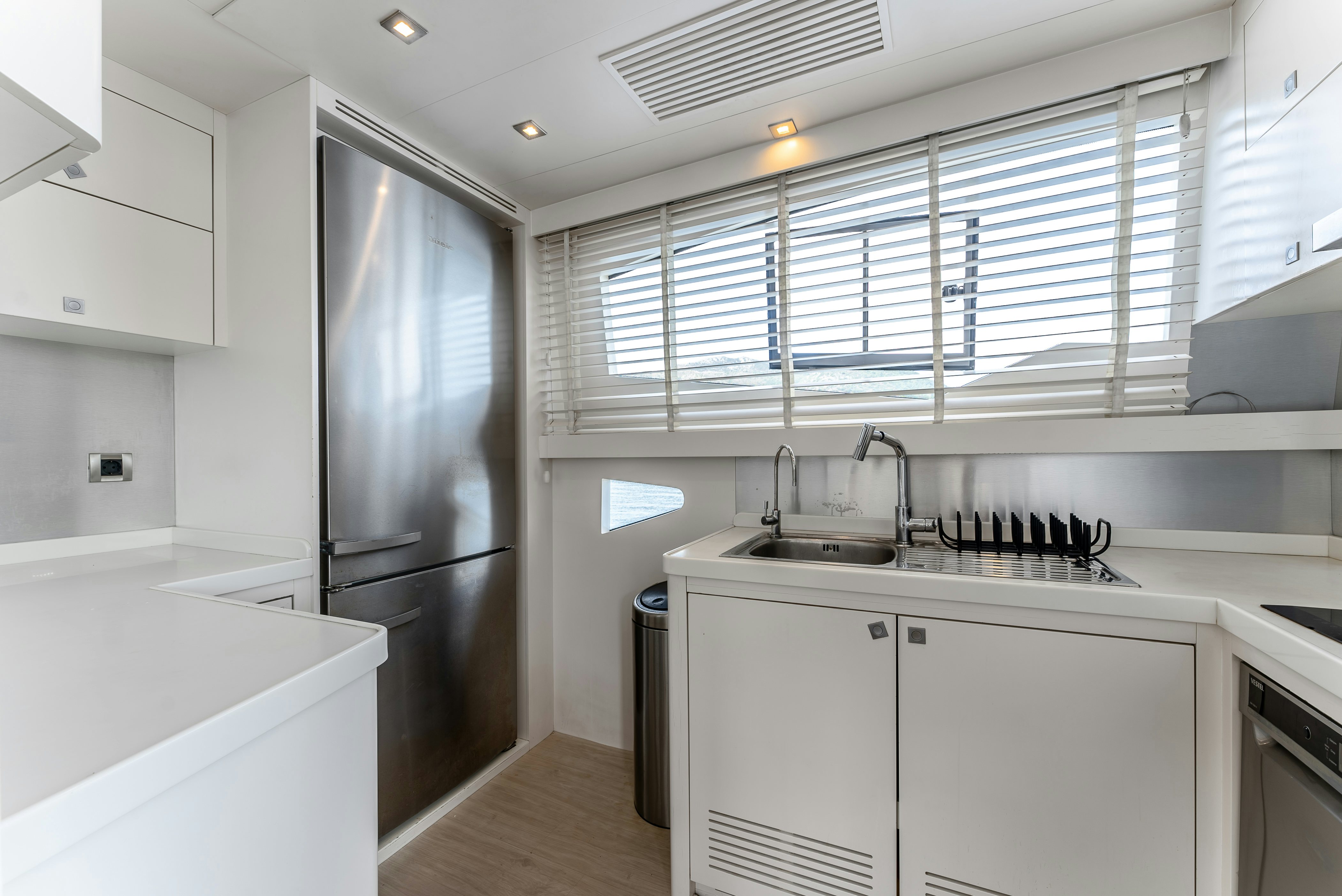 a kitchen with white cabinets aboard LADY F Yacht for Sale