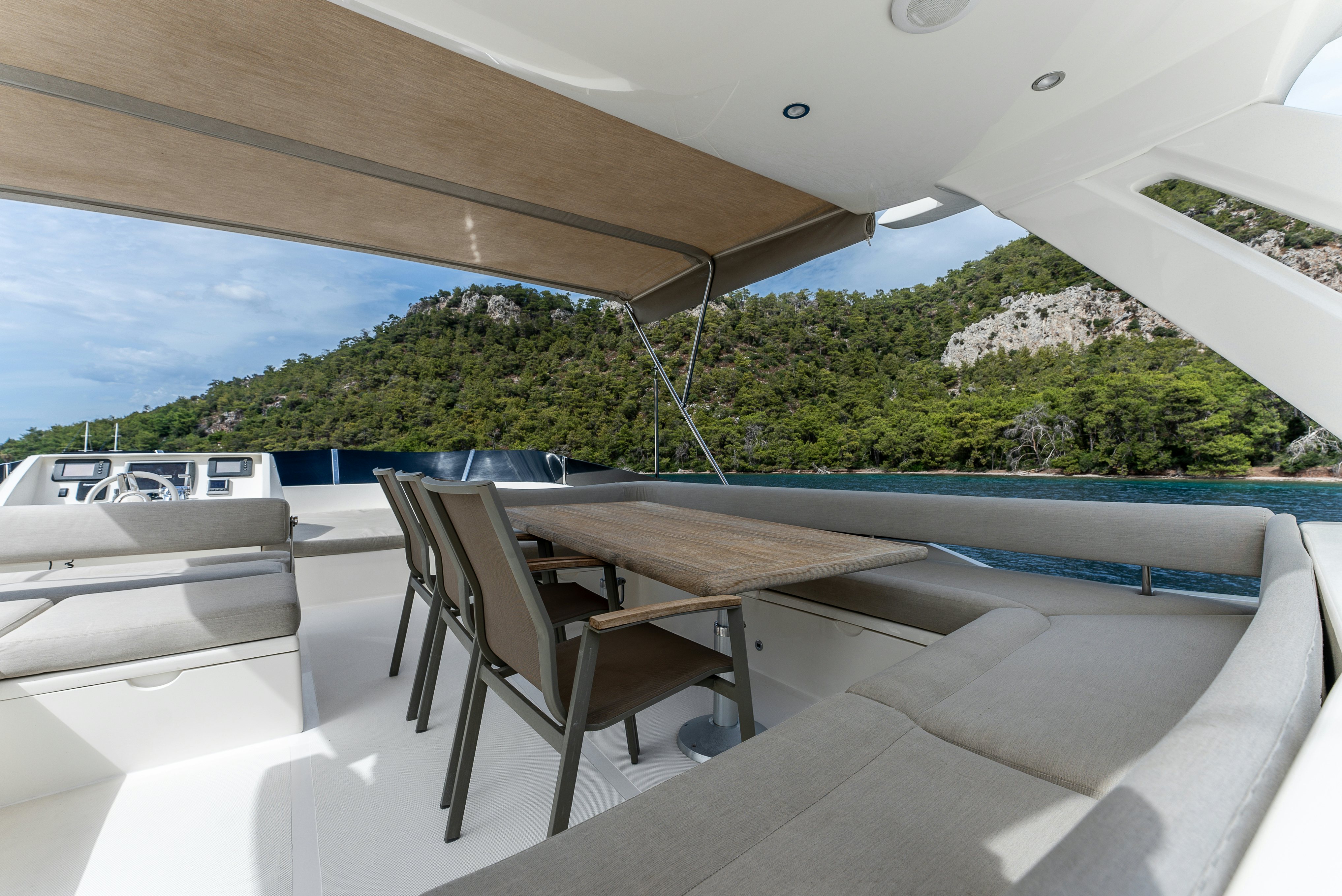 a table and chairs on a deck aboard LADY F Yacht for Sale