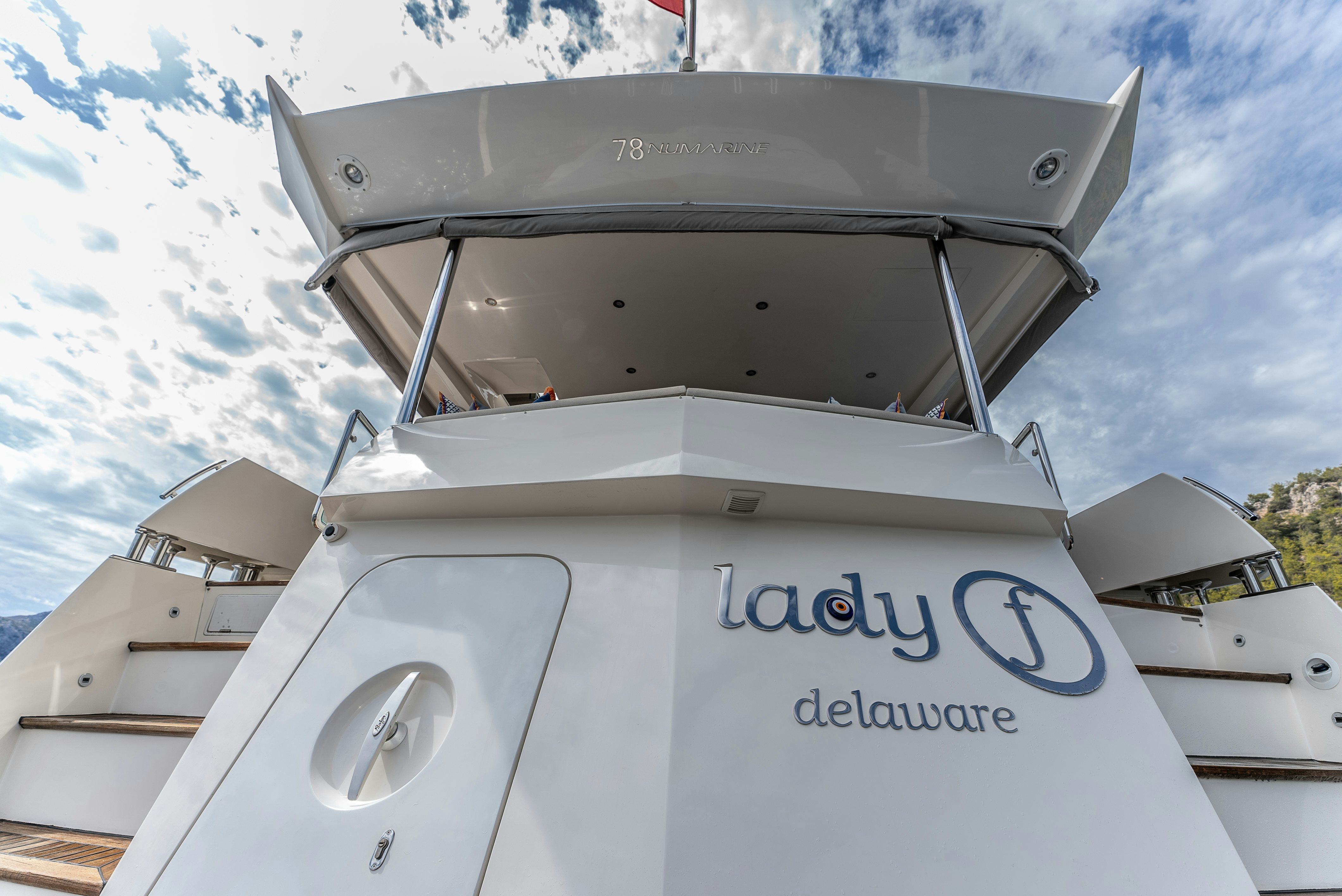 a white boat with a sign on it aboard LADY F Yacht for Sale