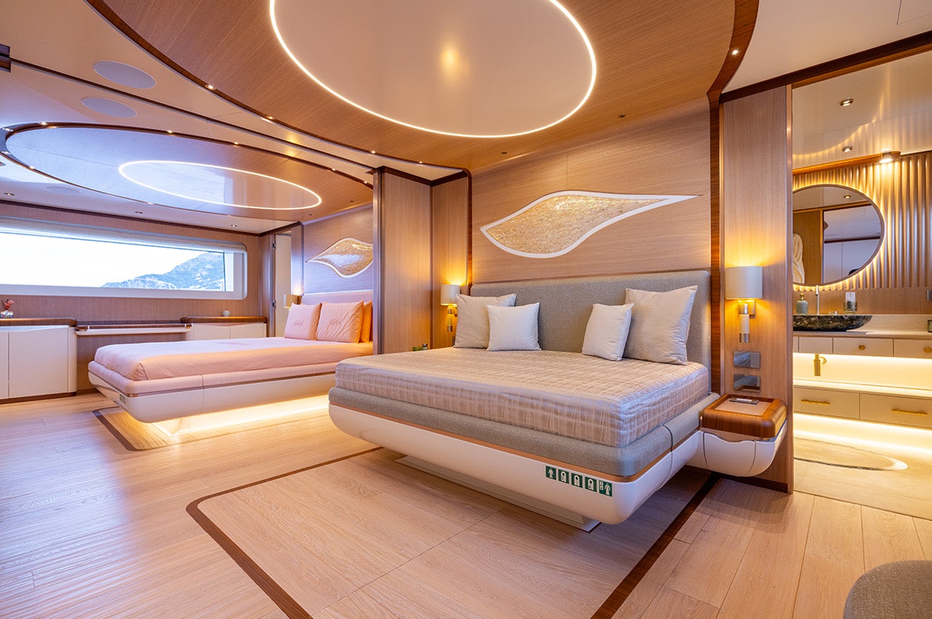 a room with a bed and a large mirror aboard ANJELIF Yacht for Charter