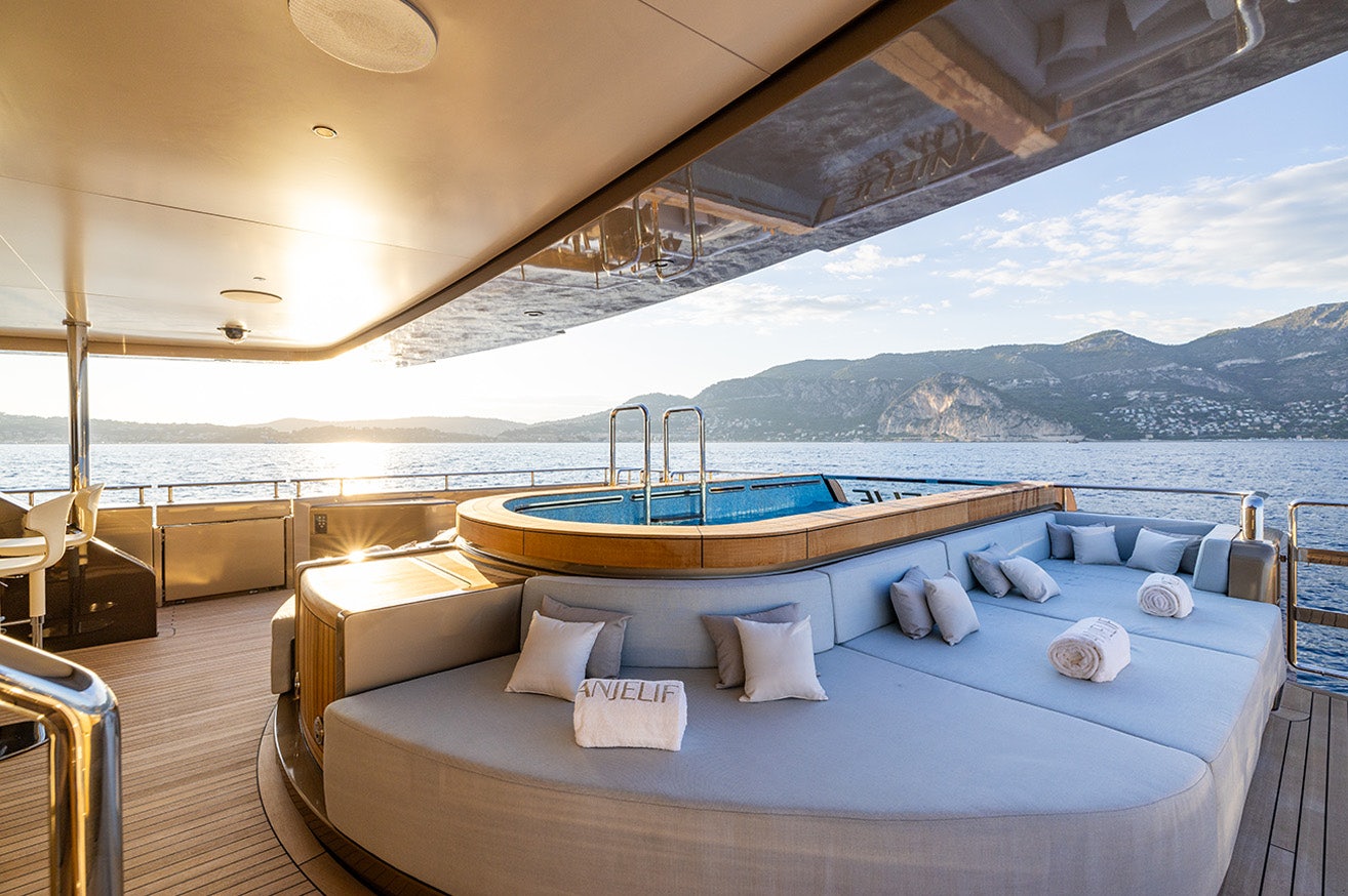 a large bed on a deck aboard ANJELIF Yacht for Charter