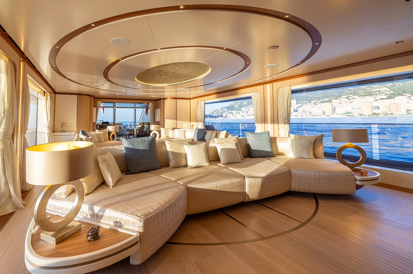a large bed with a chandelier above it aboard ANJELIF Yacht for Charter