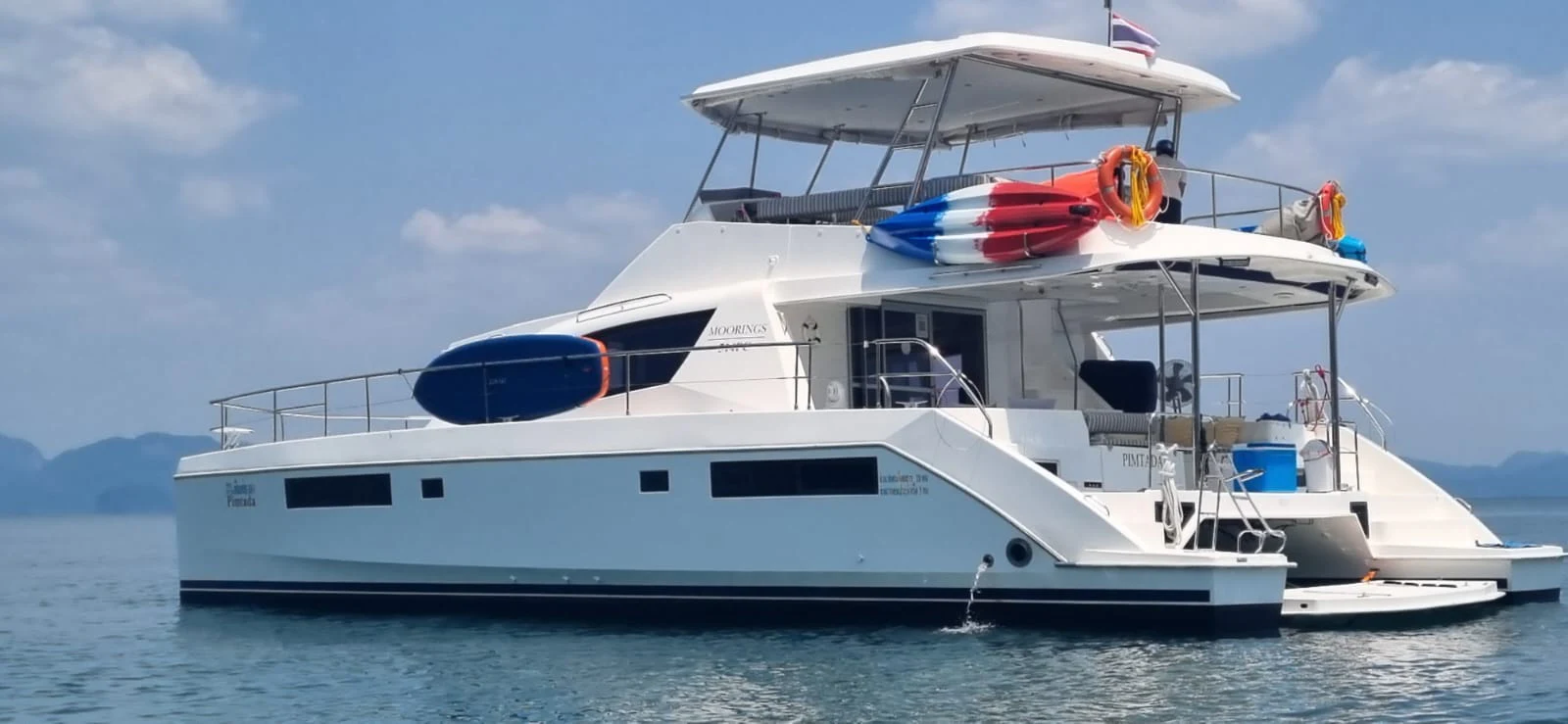 a white yacht in the water aboard HARMONY CAT Yacht for Sale