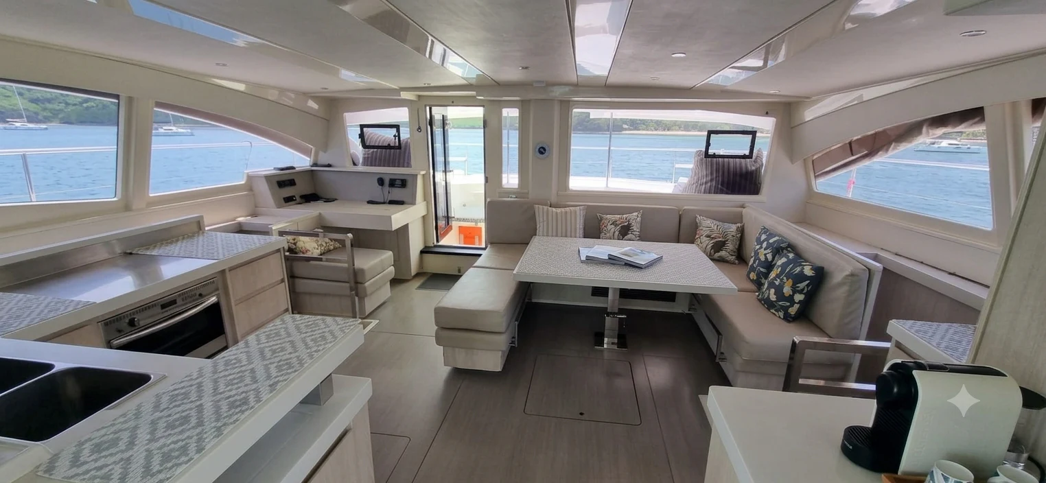 a living room with a couch and a table aboard HARMONY CAT Yacht for Sale