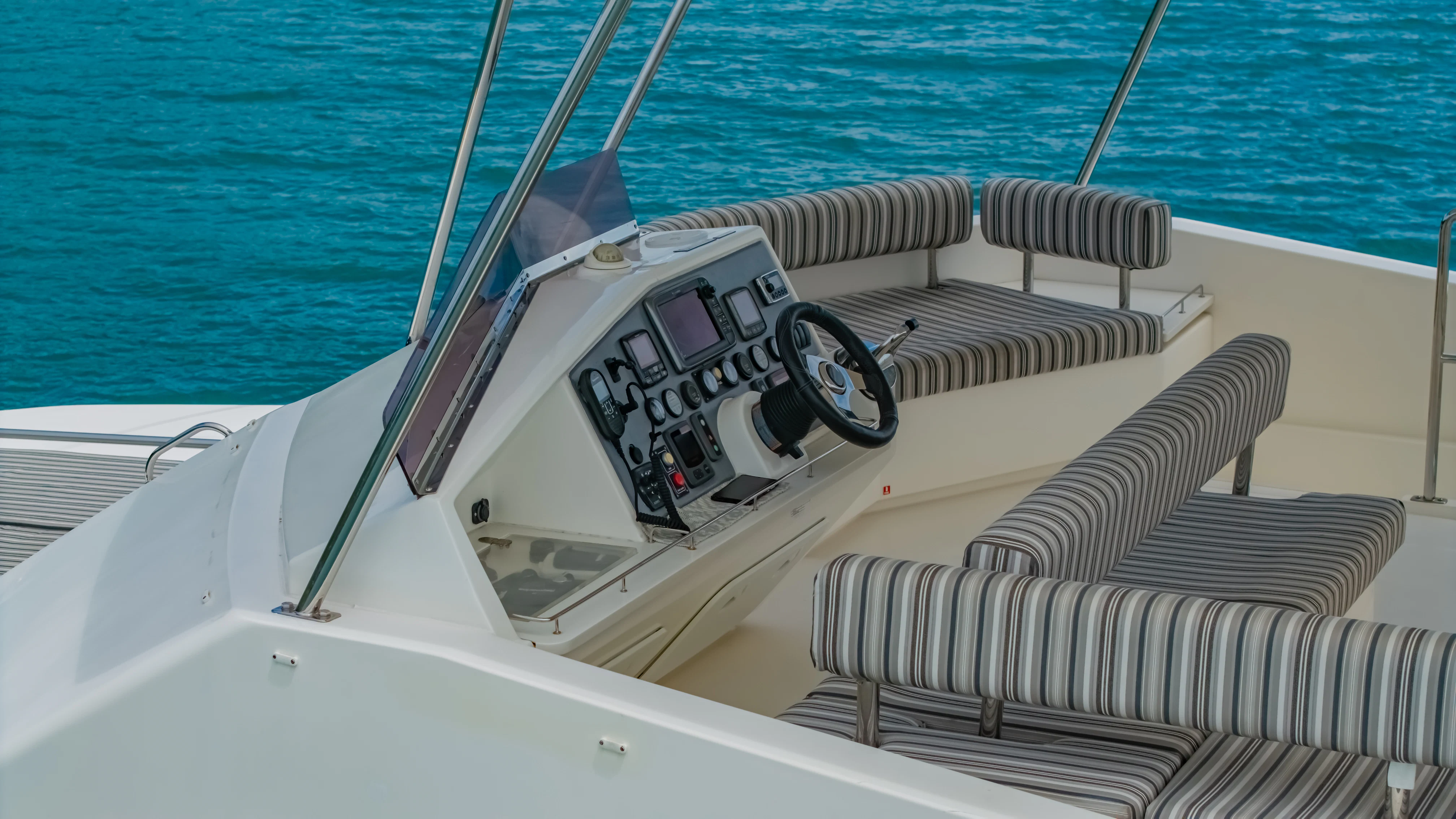 a white boat with black text on it aboard HARMONY CAT Yacht for Sale