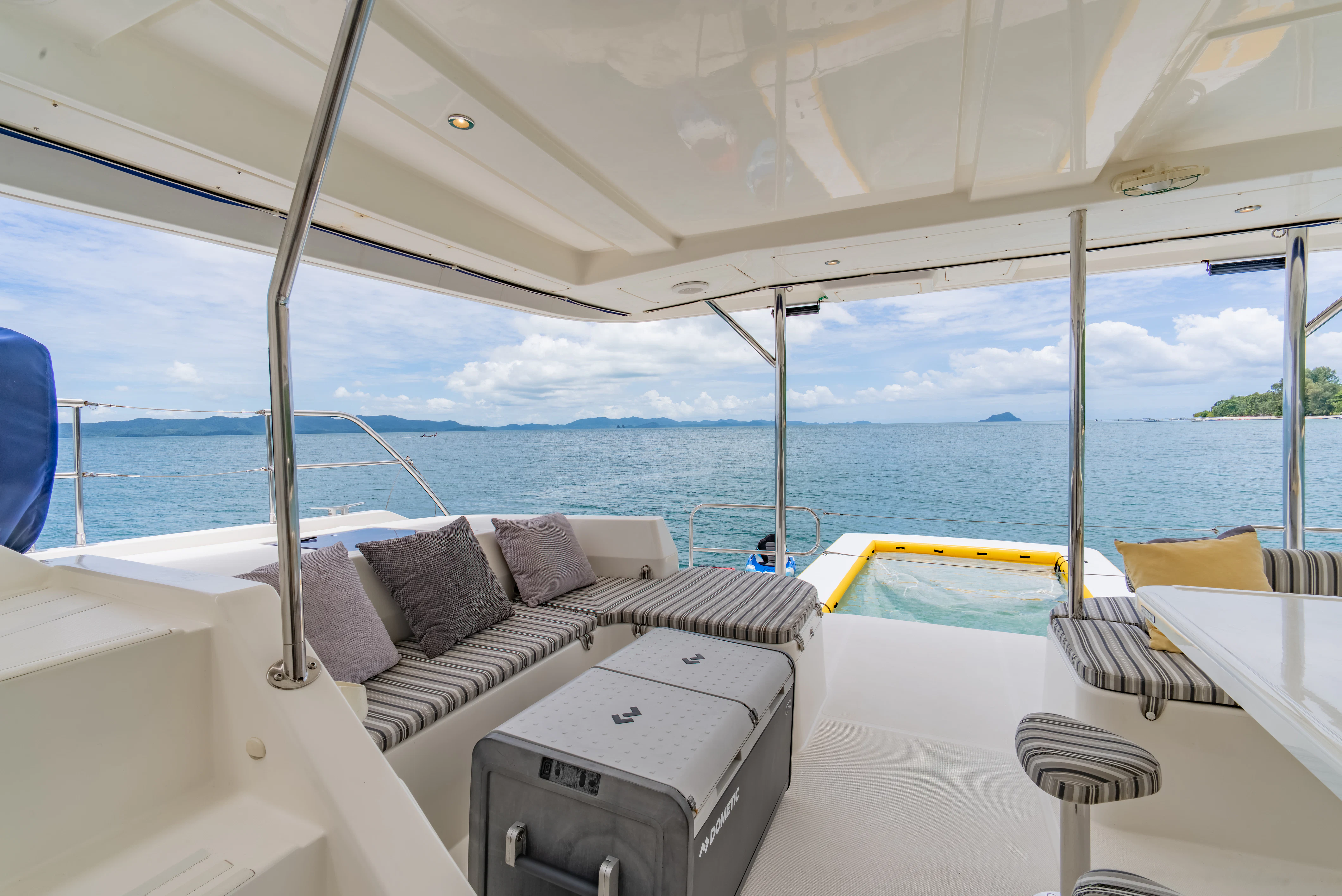 a boat with a couch and a table on it aboard HARMONY CAT Yacht for Sale