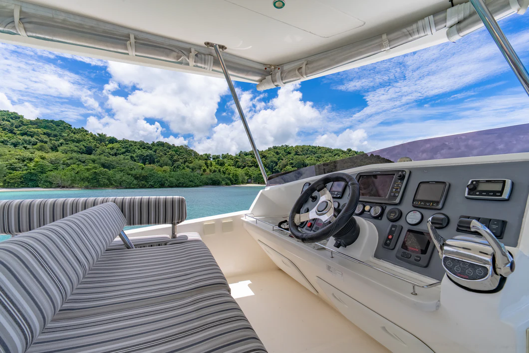 a boat with a steering wheel and a boat in the water aboard HARMONY CAT Yacht for Sale