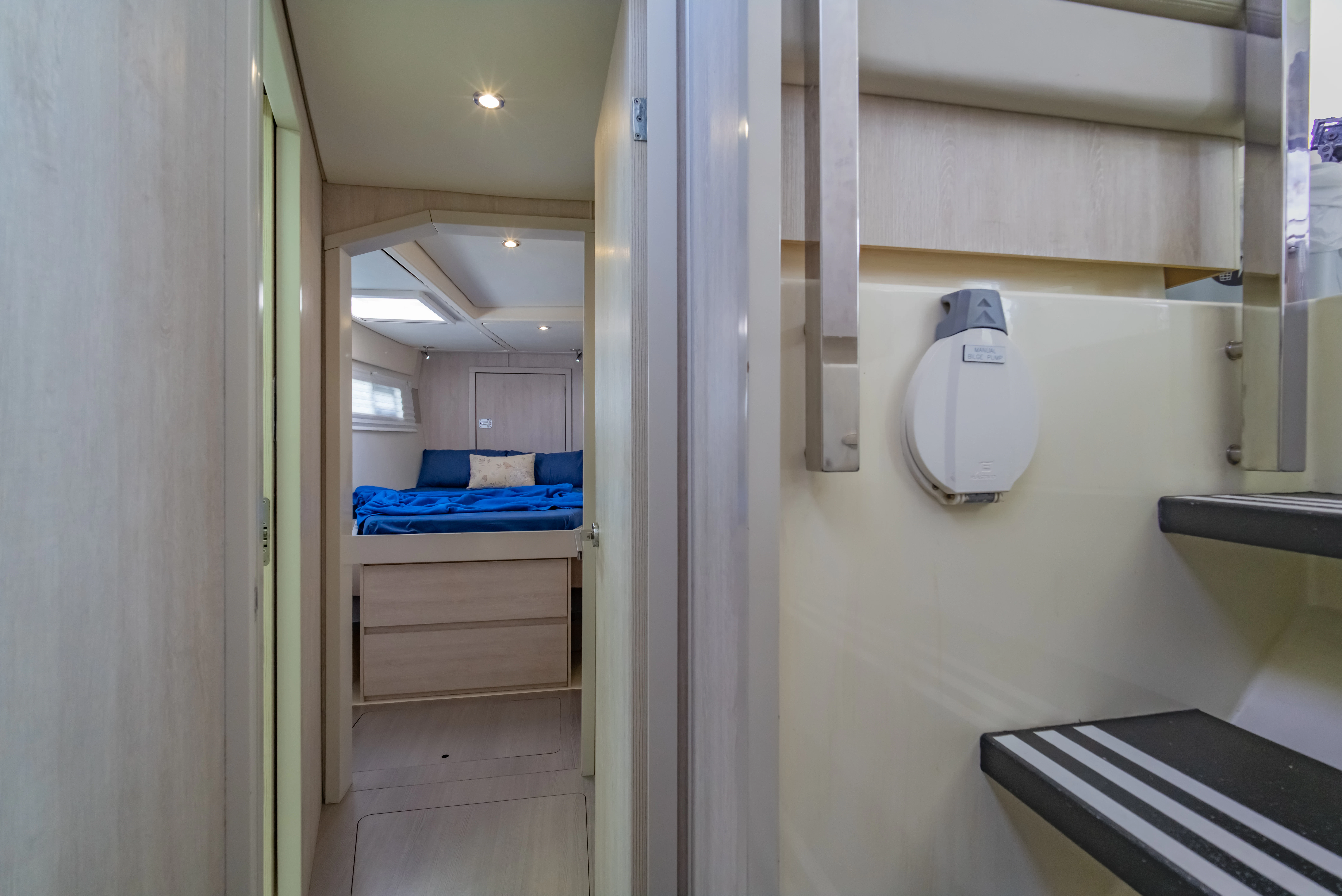 a room with a bed and a telephone aboard HARMONY CAT Yacht for Sale