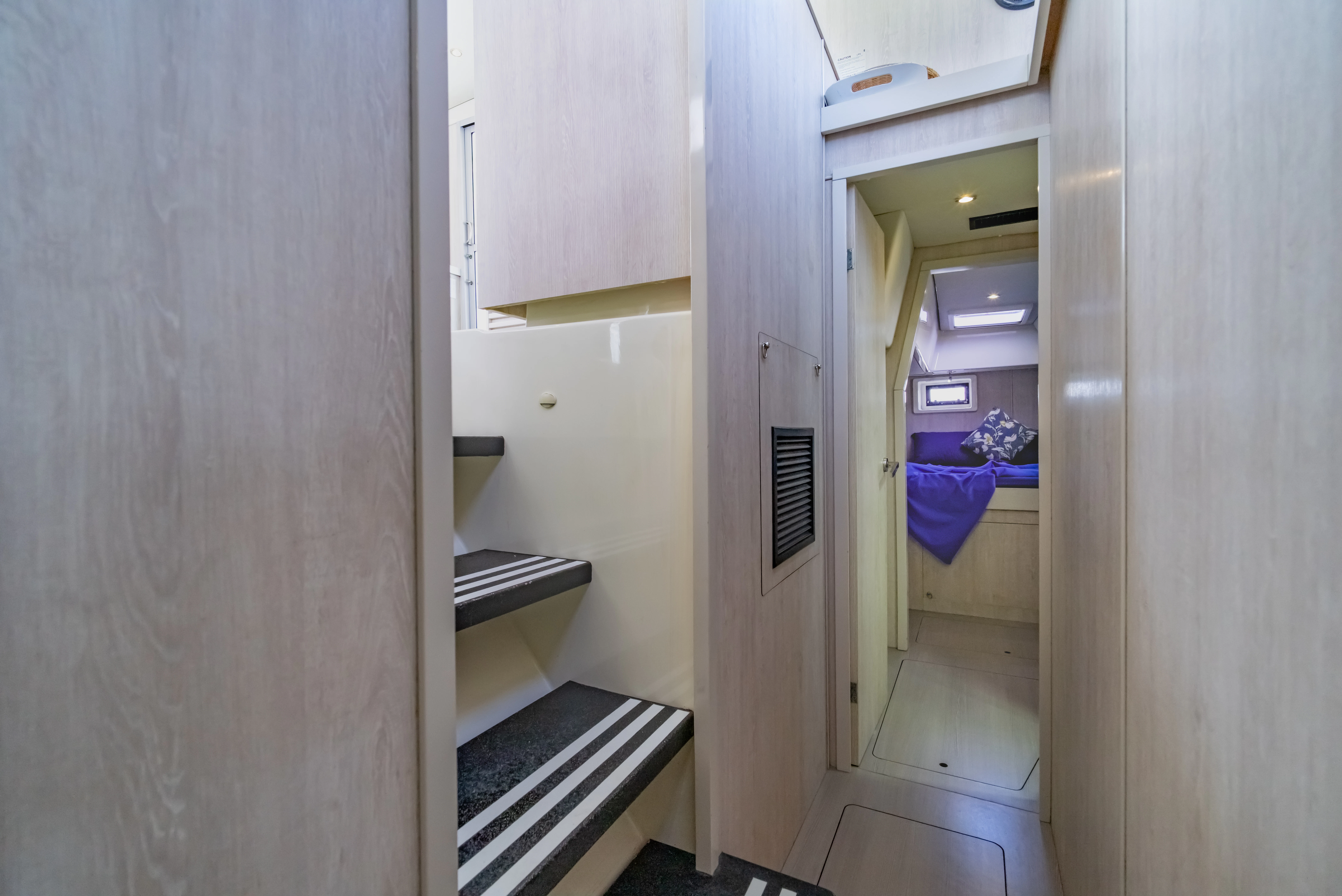 a hallway with a purple towel from the ceiling aboard HARMONY CAT Yacht for Sale