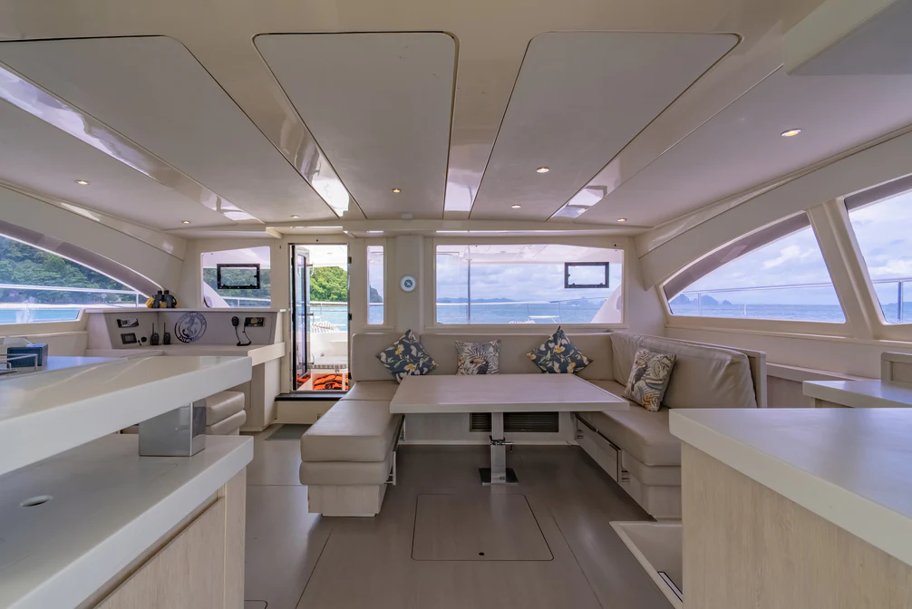 a room with a couch and a table aboard HARMONY CAT Yacht for Sale