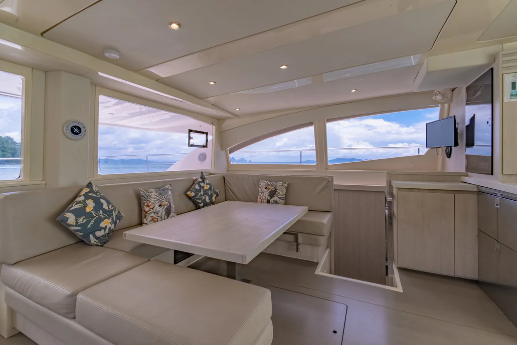 a room with a couch and a table aboard HARMONY CAT Yacht for Sale