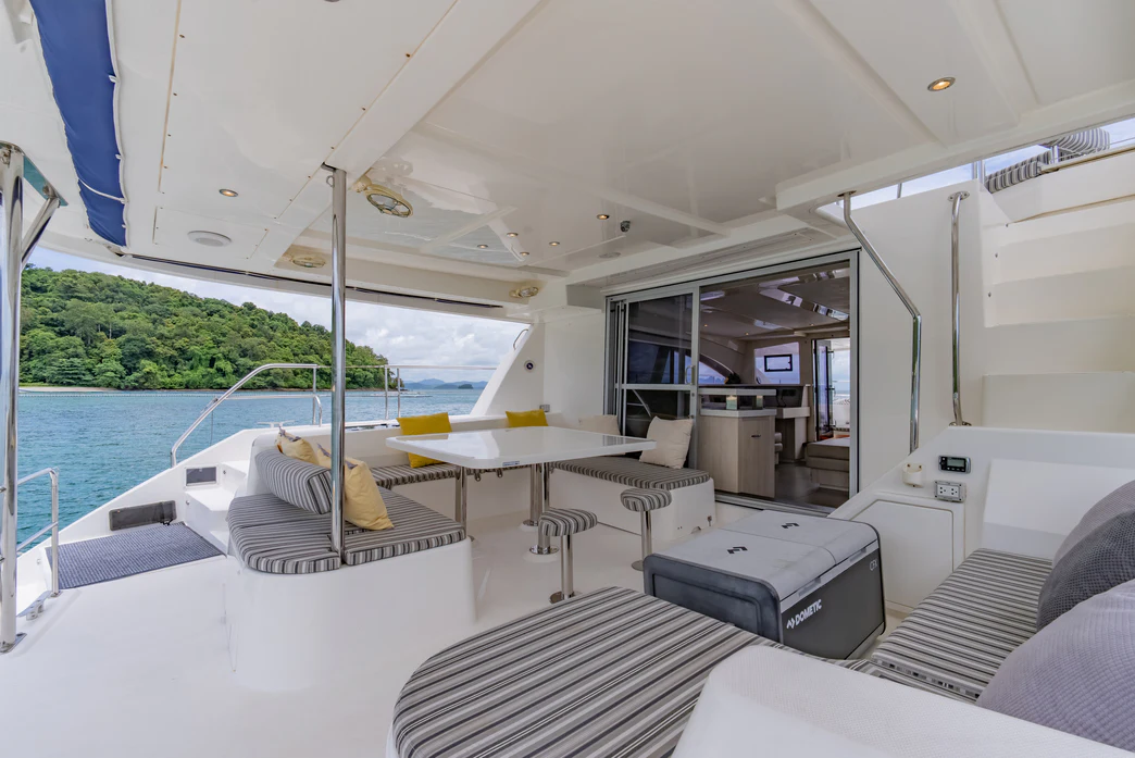 a room with a pool and a table and chairs aboard HARMONY CAT Yacht for Sale