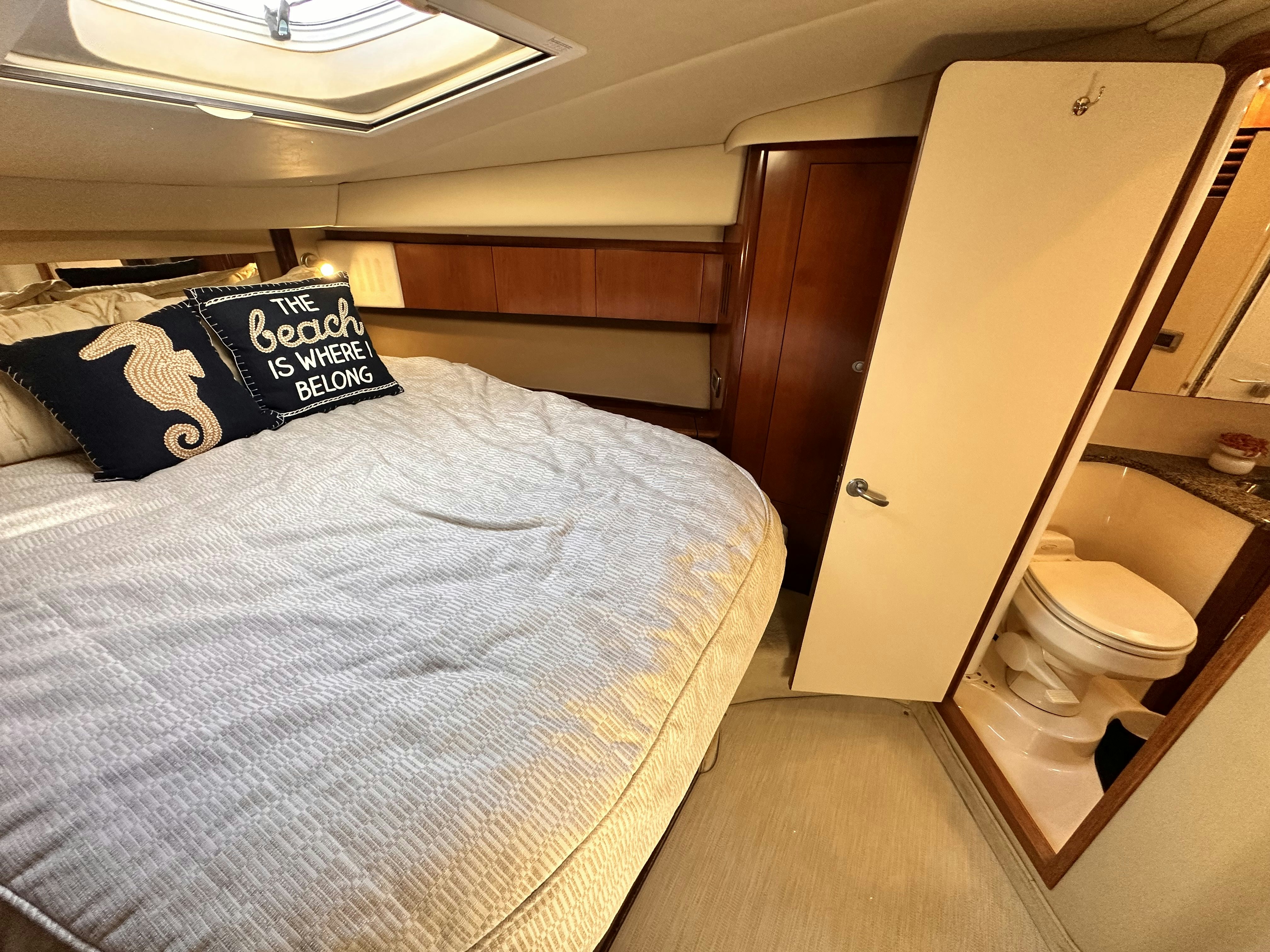 a small bedroom with a bed aboard LANAKILA Yacht for Sale