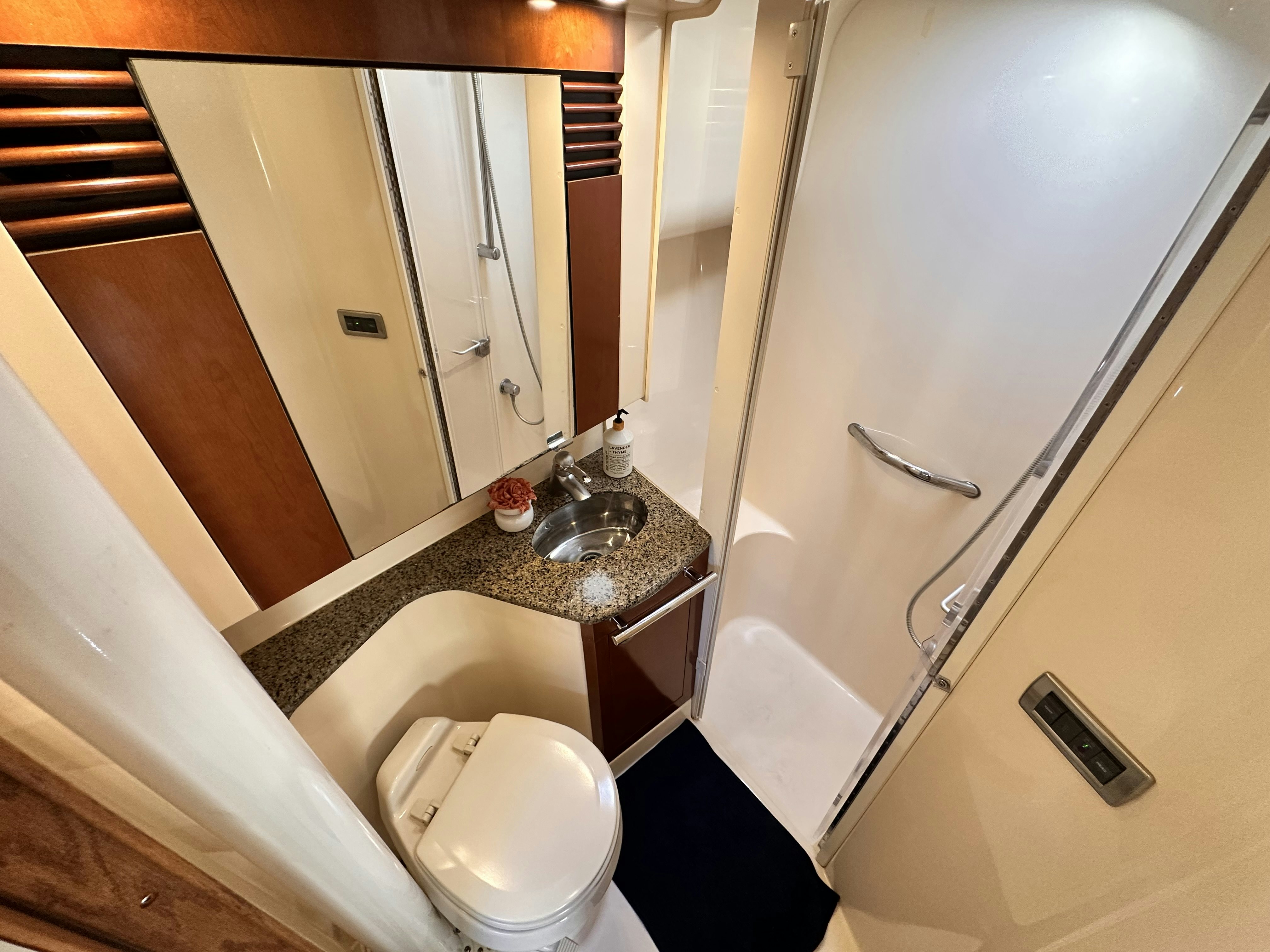 a bathroom with a glass shower aboard LANAKILA Yacht for Sale