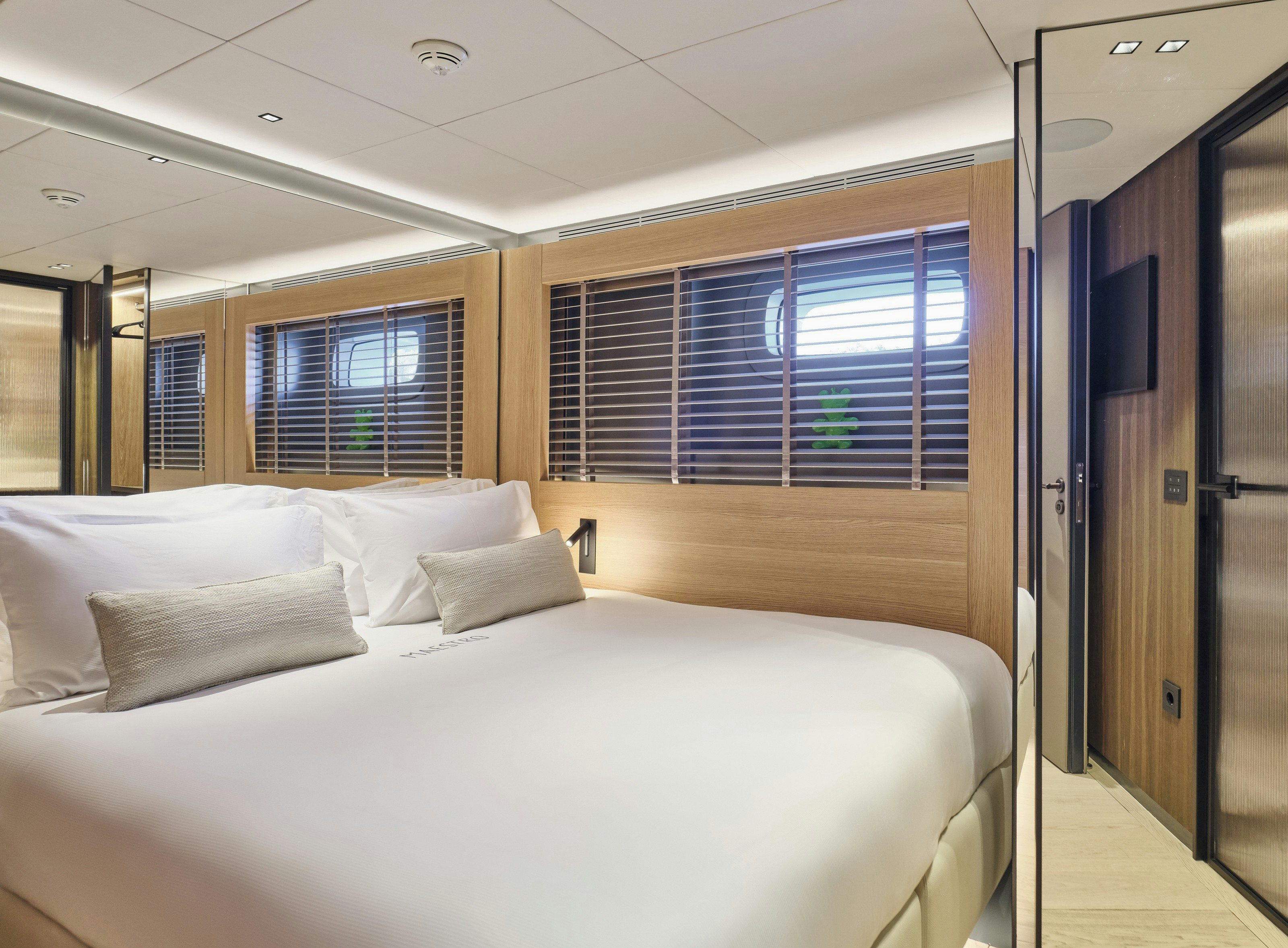 a bed with white sheets aboard MAESTRO Yacht for Charter