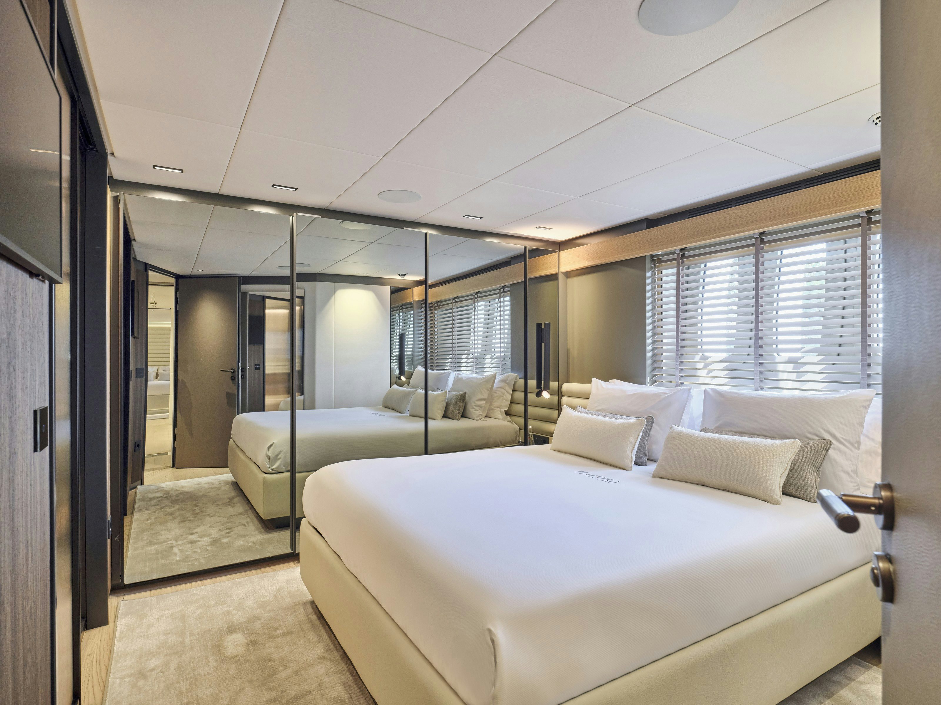 a room with a bed and a window aboard MAESTRO Yacht for Charter