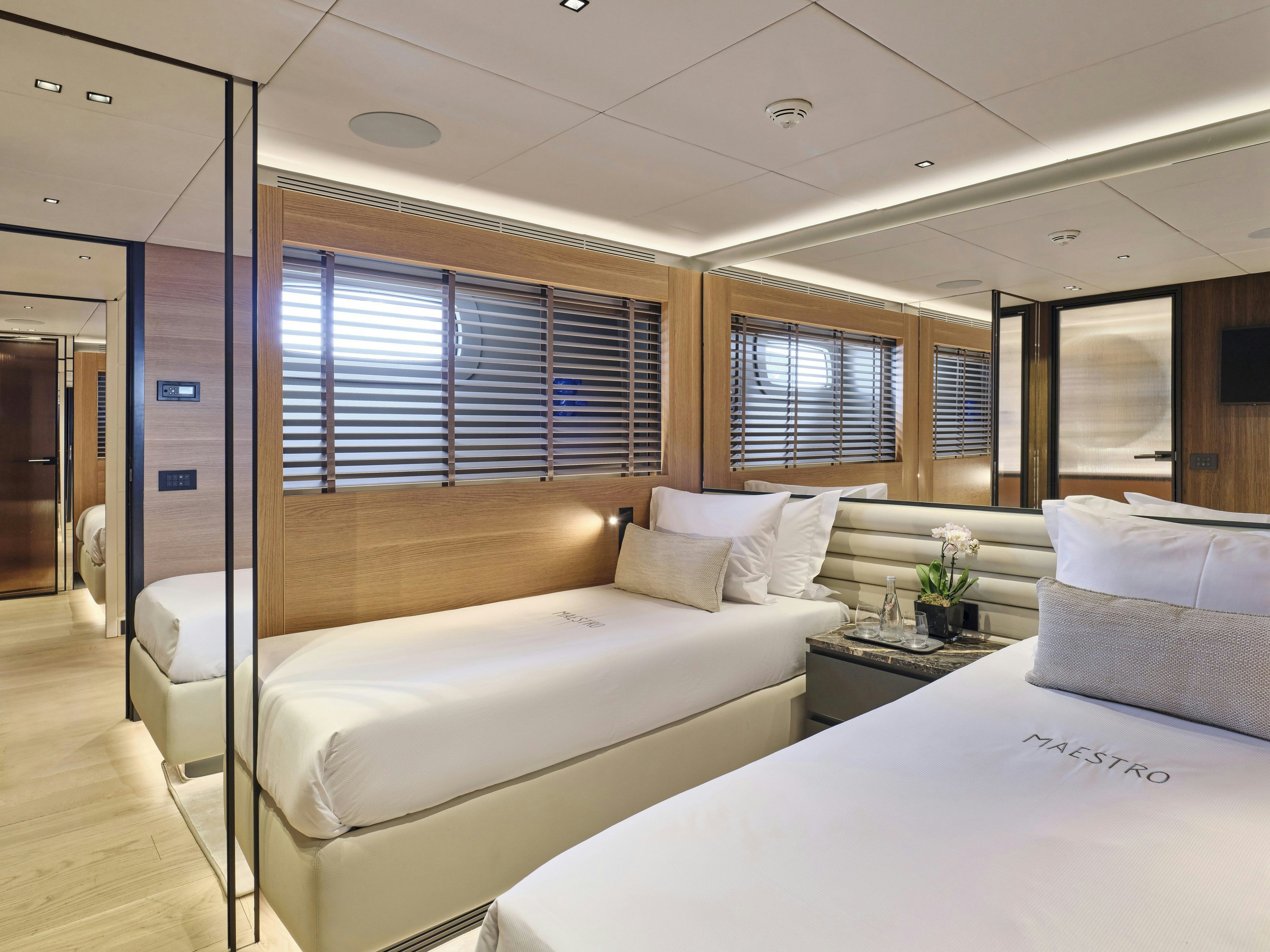 a room with two beds aboard MAESTRO Yacht for Charter