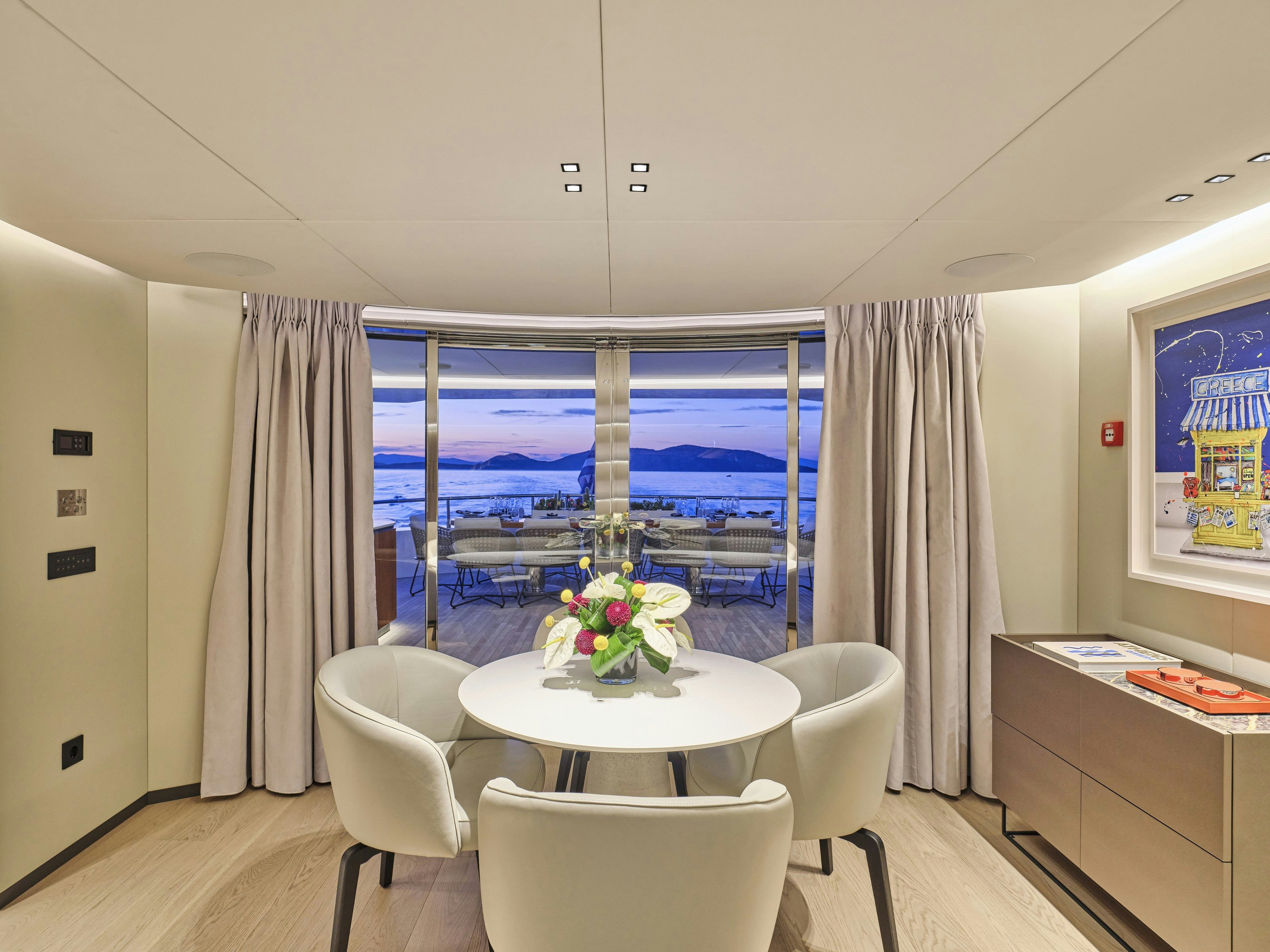 a room with a table and chairs aboard MAESTRO Yacht for Charter