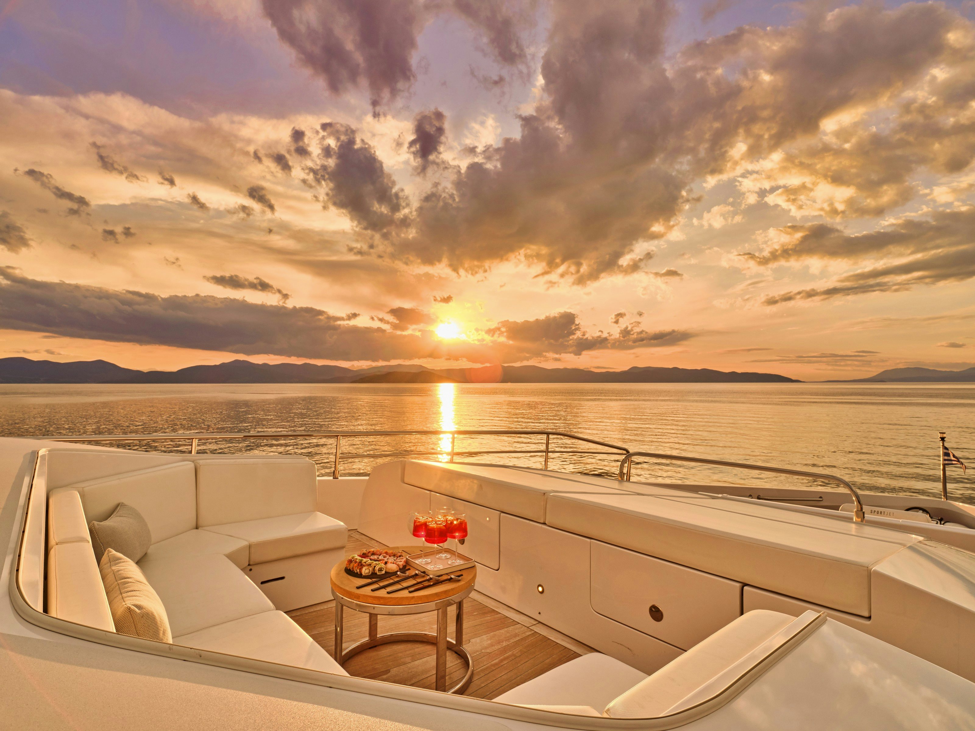 a sunset over a body of water aboard MAESTRO Yacht for Charter