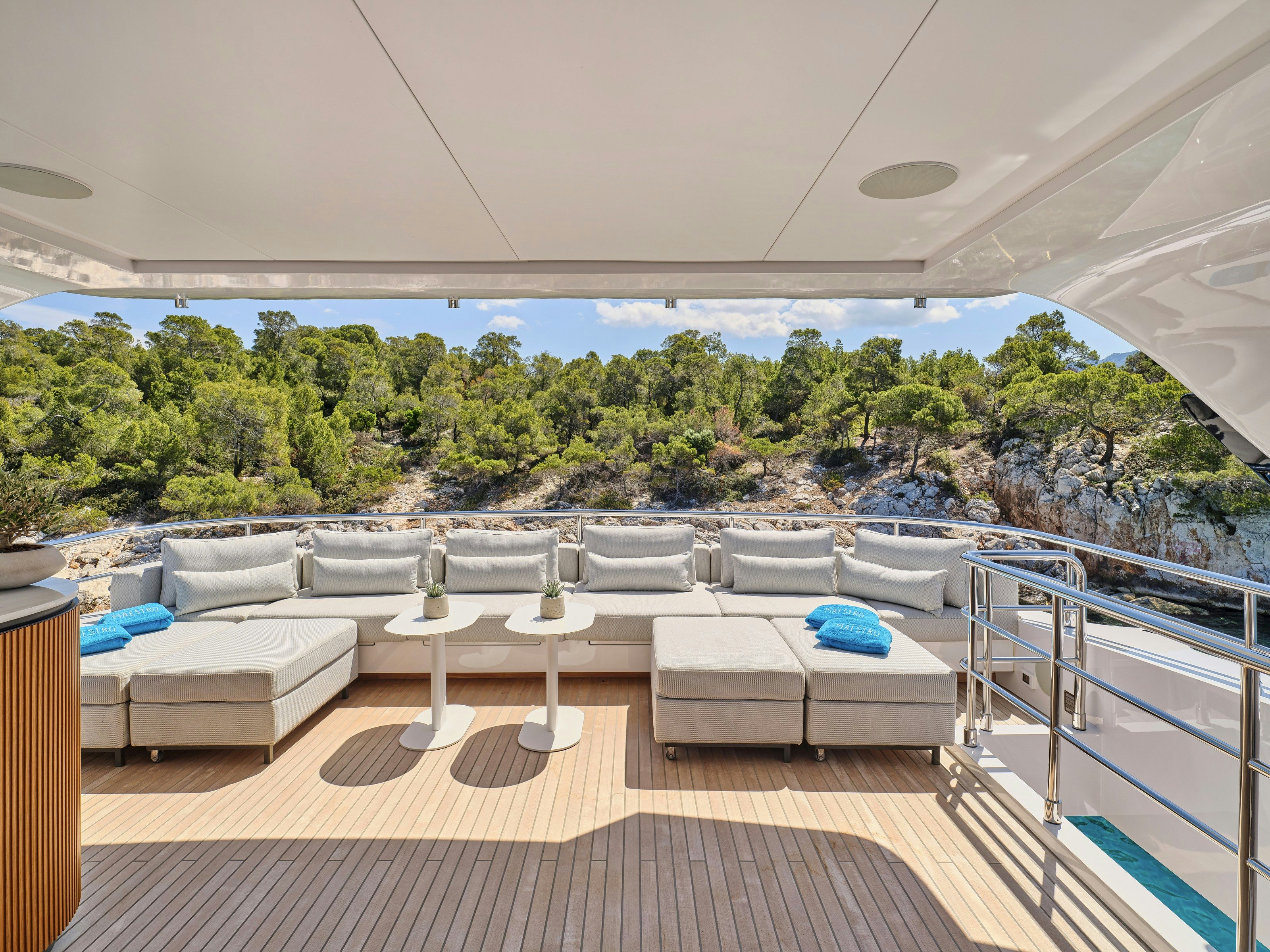 a patio with a table and chairs aboard MAESTRO Yacht for Charter