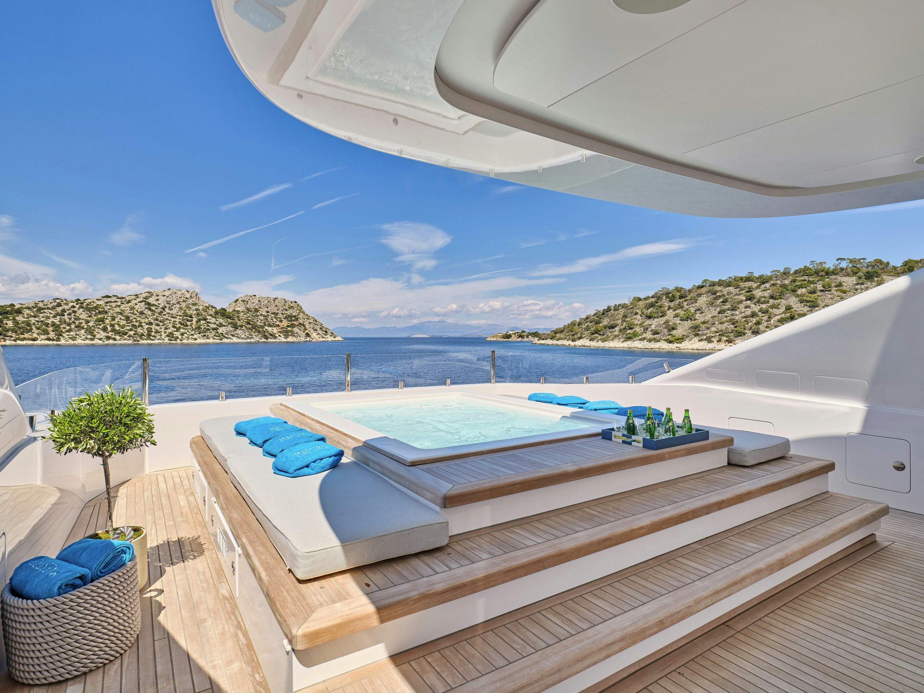 a pool with a deck and a view of the water aboard MAESTRO Yacht for Charter
