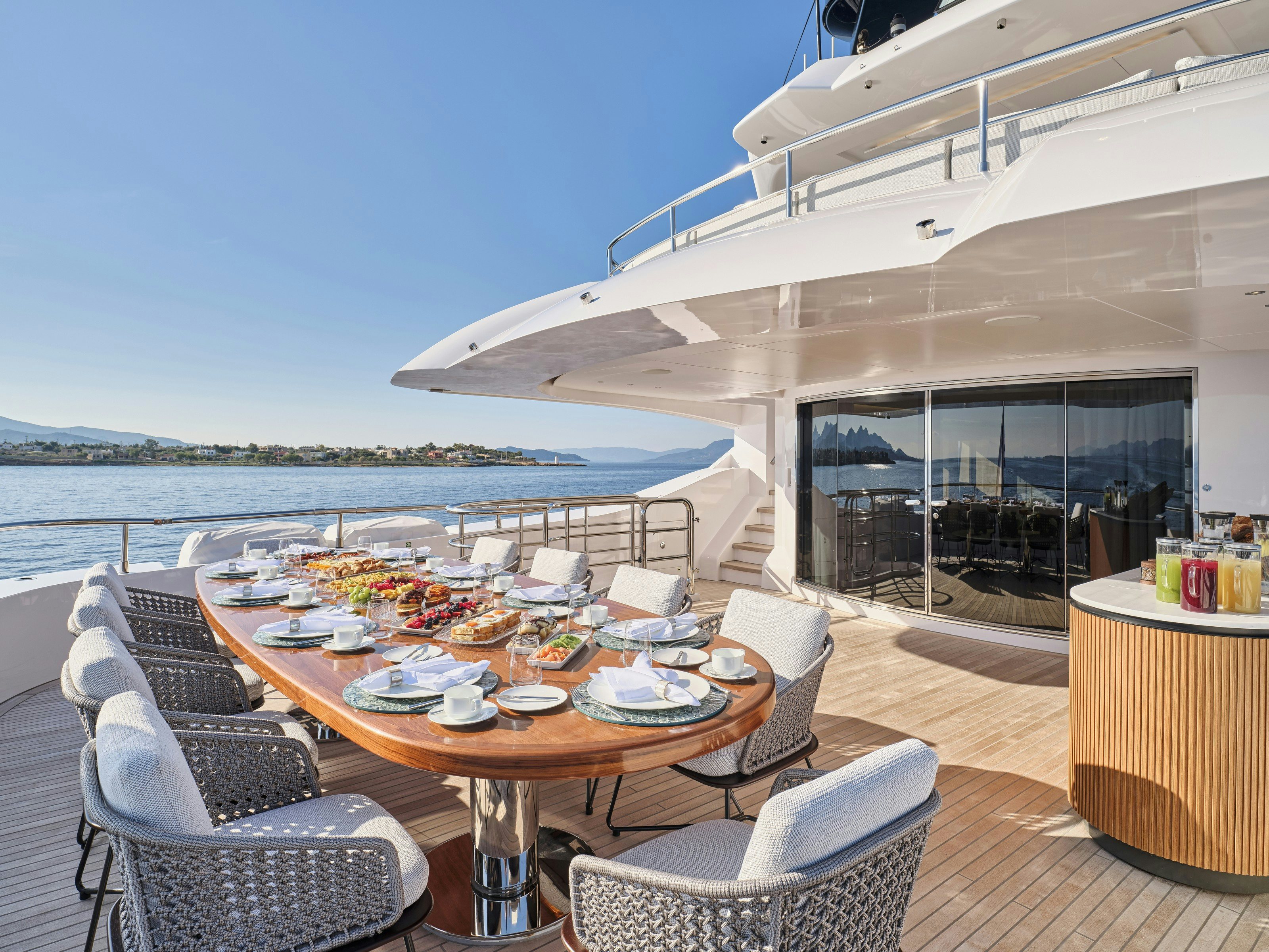a table and chairs on a deck aboard MAESTRO Yacht for Charter