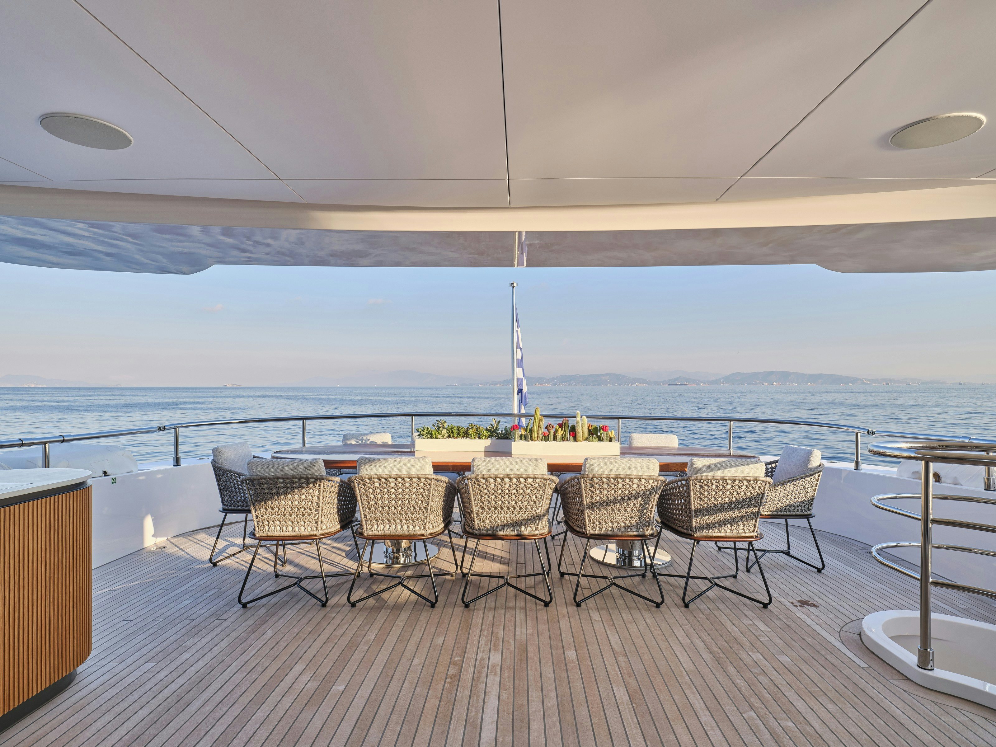 a table and chairs on a deck aboard MAESTRO Yacht for Charter