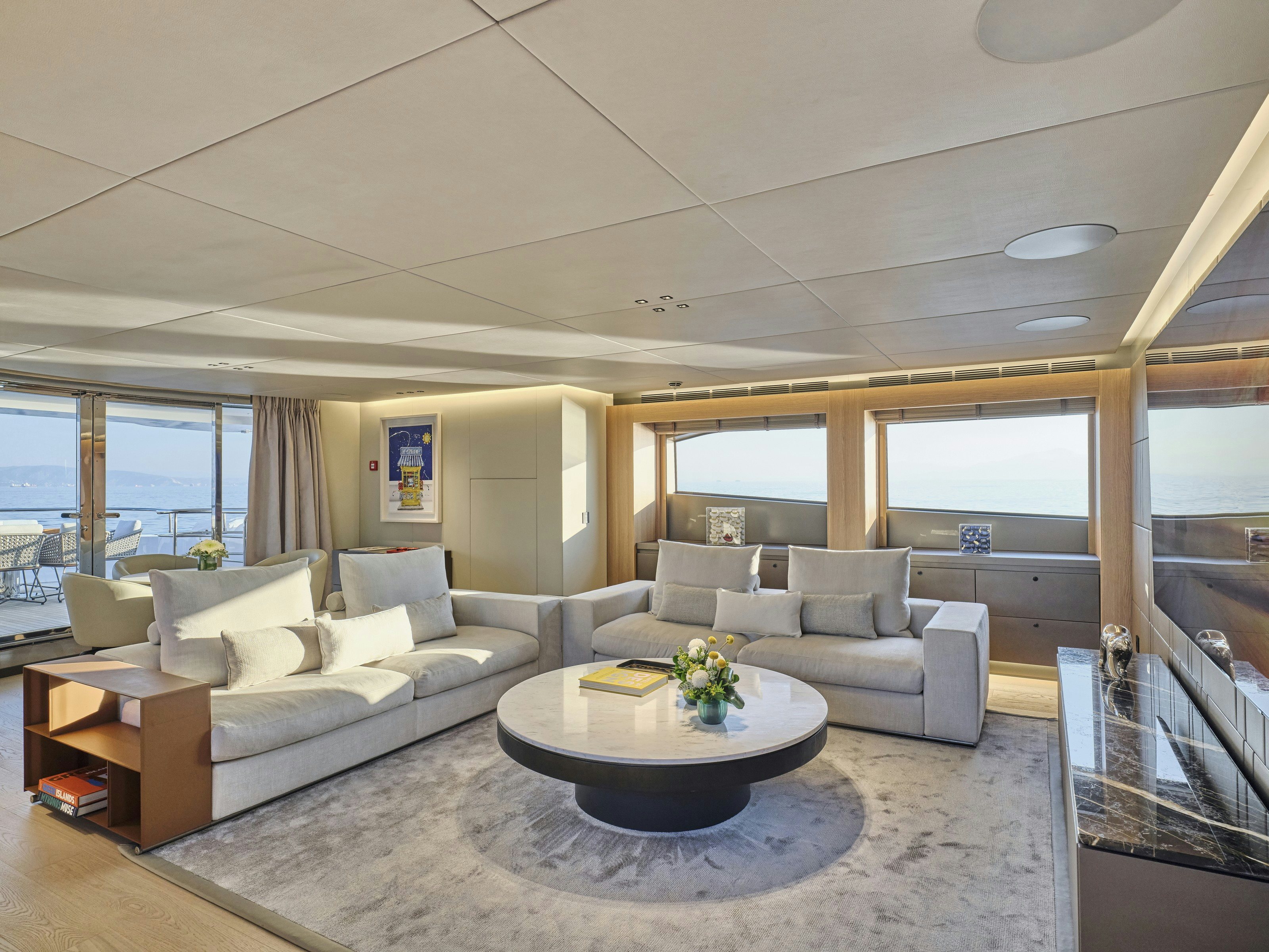 a living room with a large window aboard MAESTRO Yacht for Charter