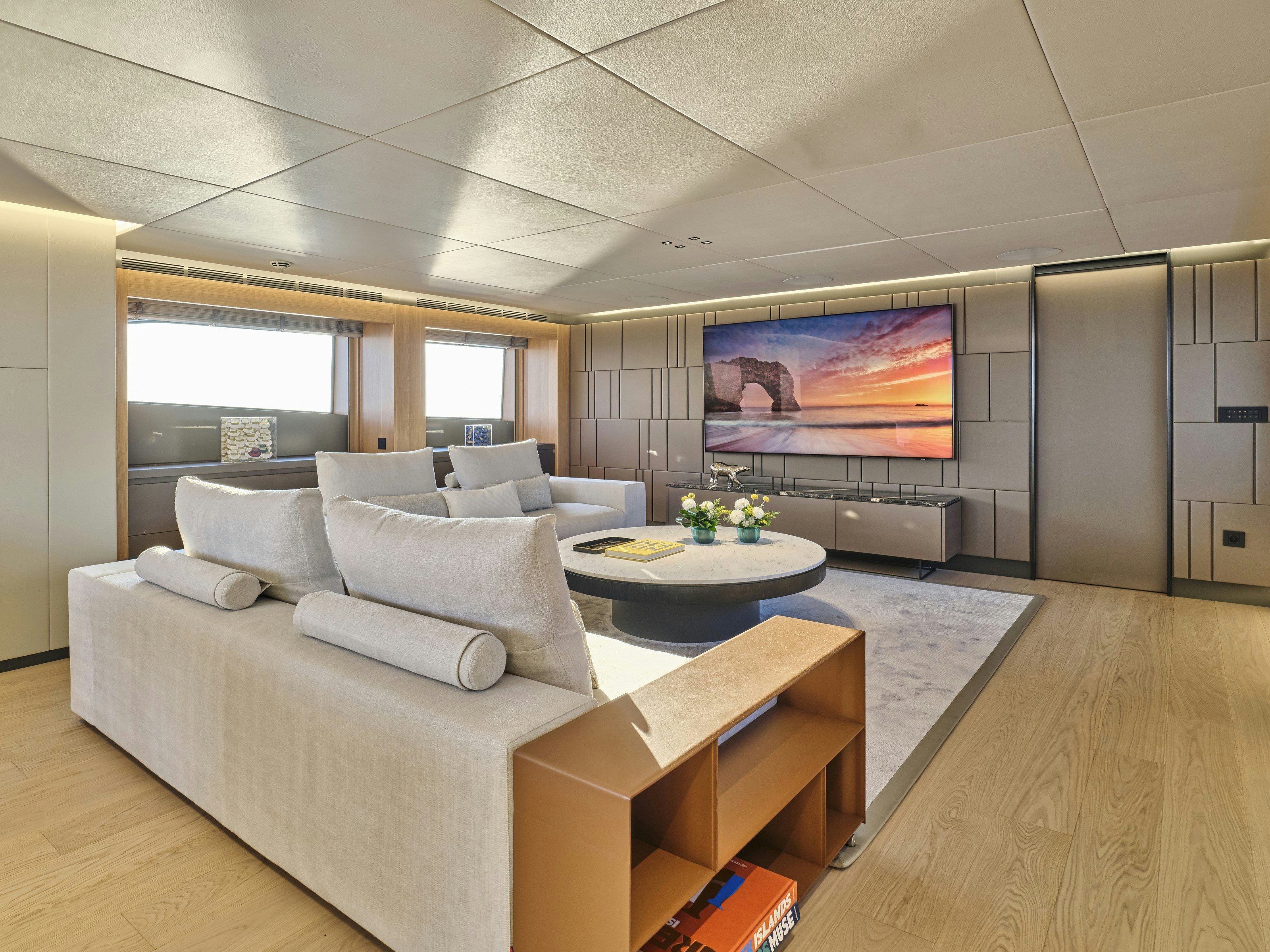 a living room with a large window aboard MAESTRO Yacht for Charter