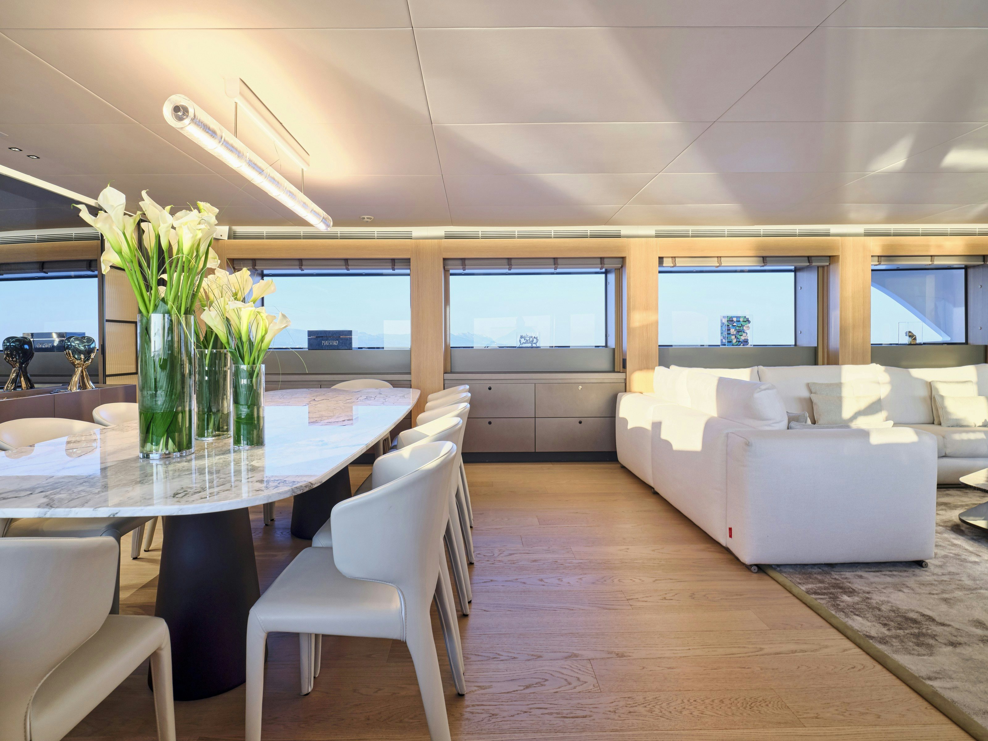 a room with a table and chairs aboard MAESTRO Yacht for Charter
