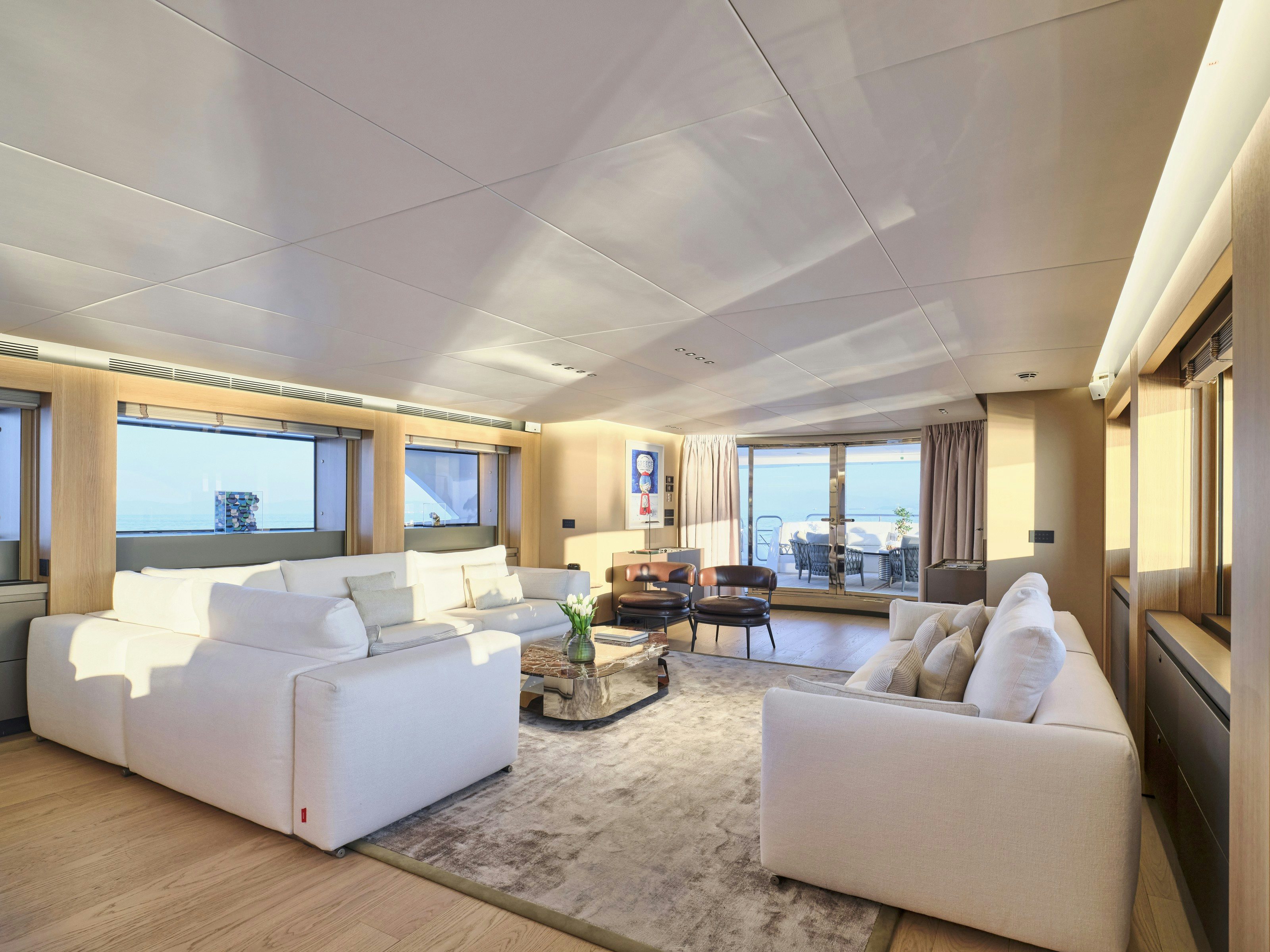 a living room with a large window aboard MAESTRO Yacht for Charter