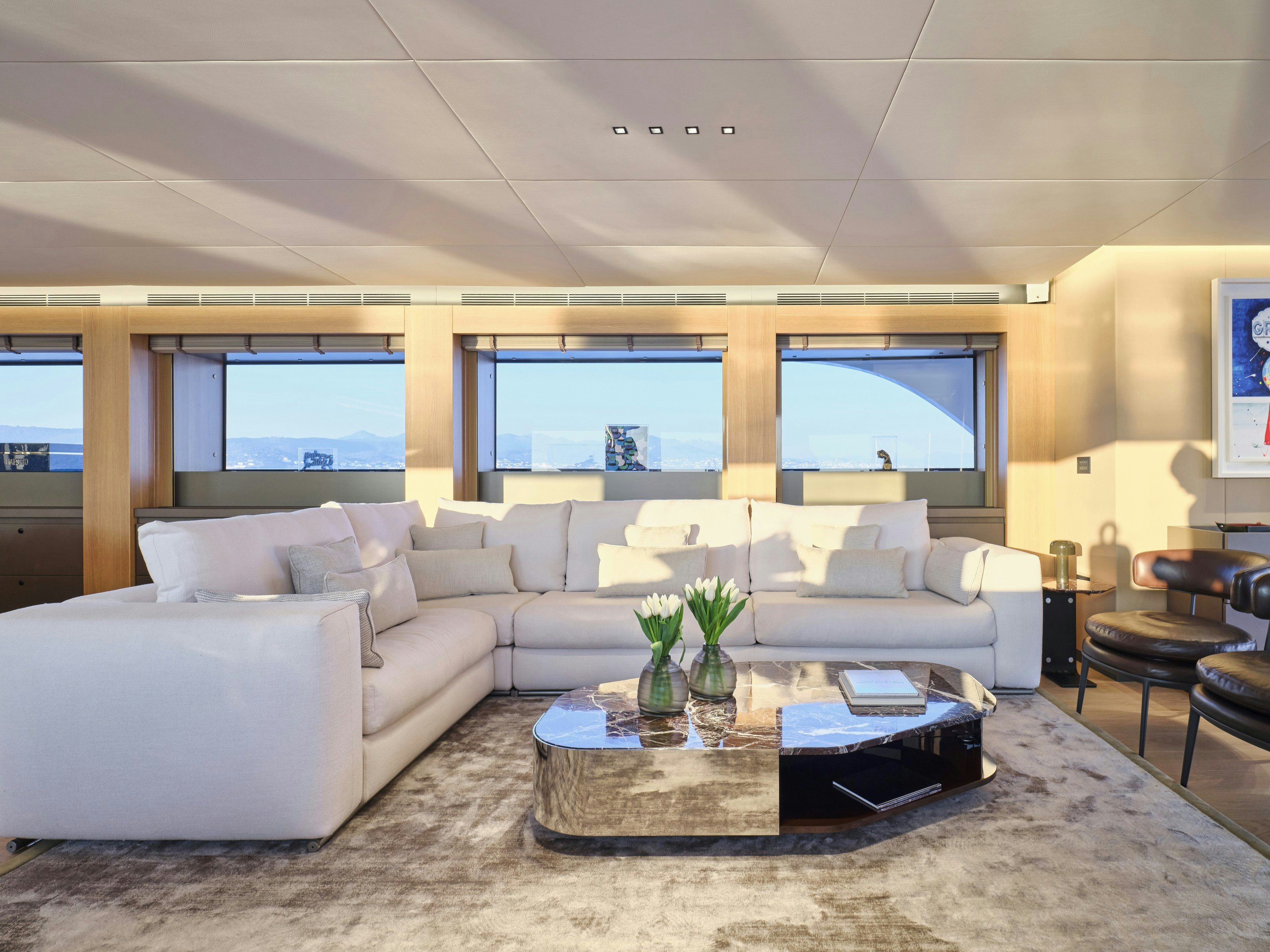 a living room with a large window aboard MAESTRO Yacht for Charter
