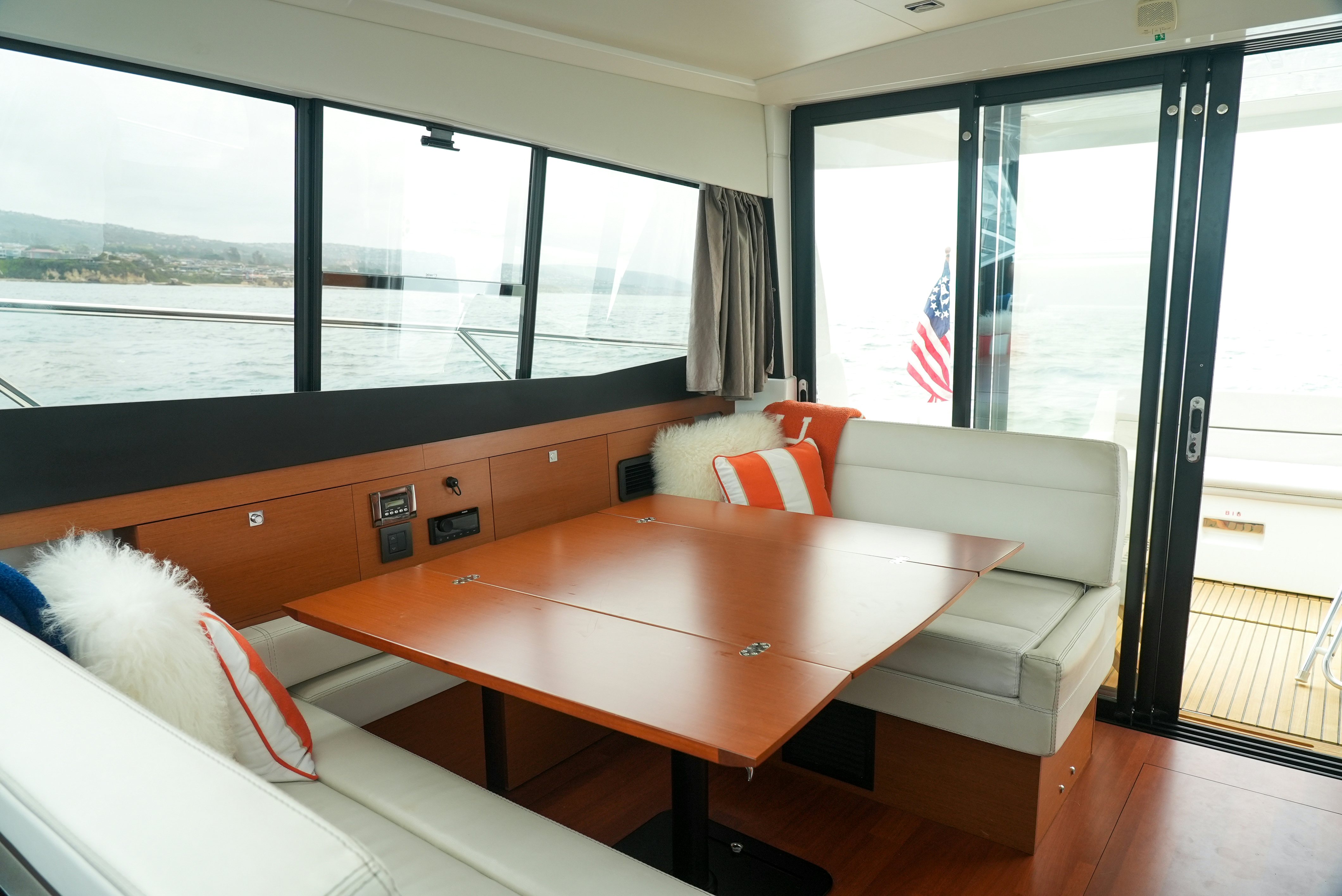 a room with a table and couches aboard DARK SIDE Yacht for Sale