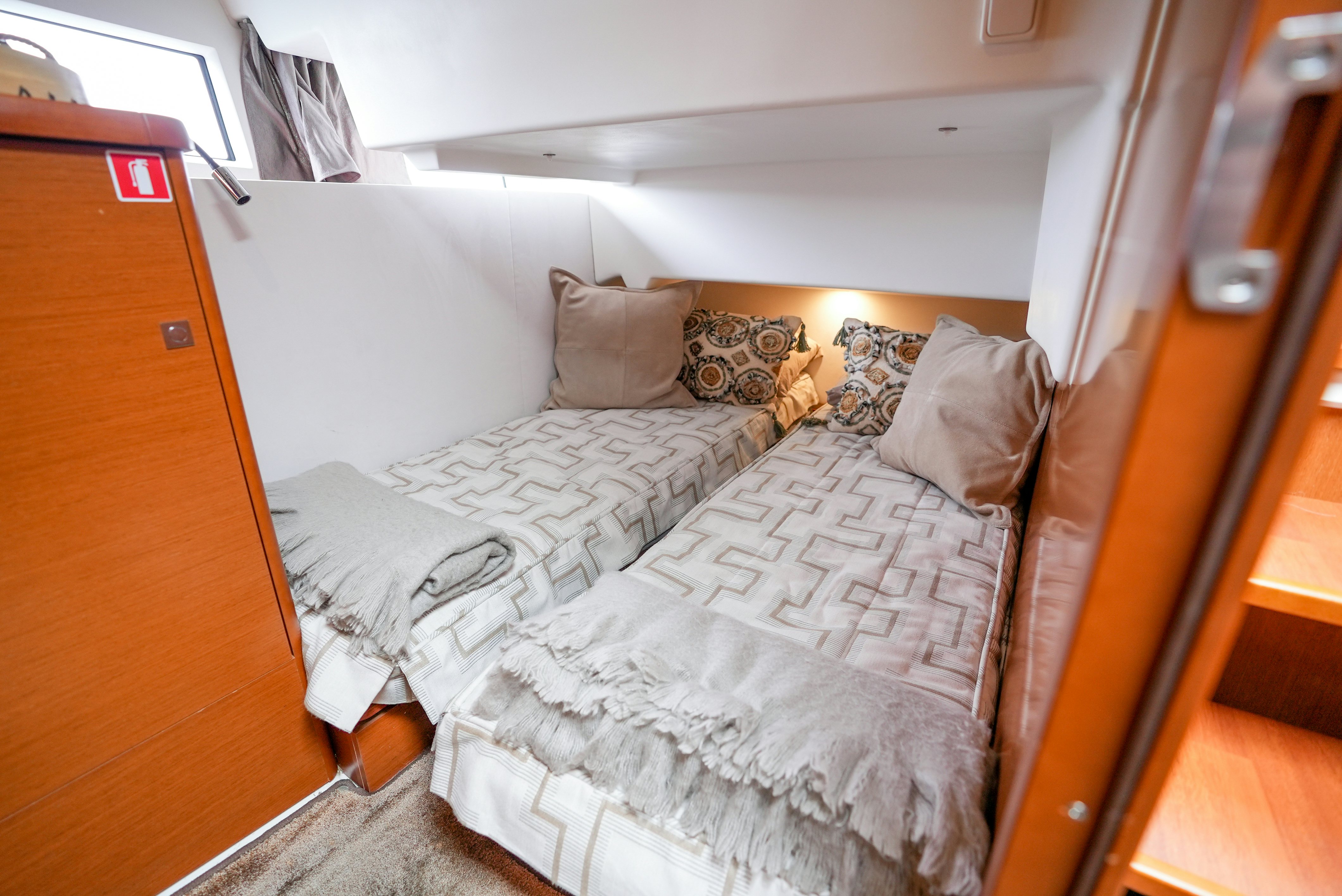a bedroom with two beds aboard DARK SIDE Yacht for Sale