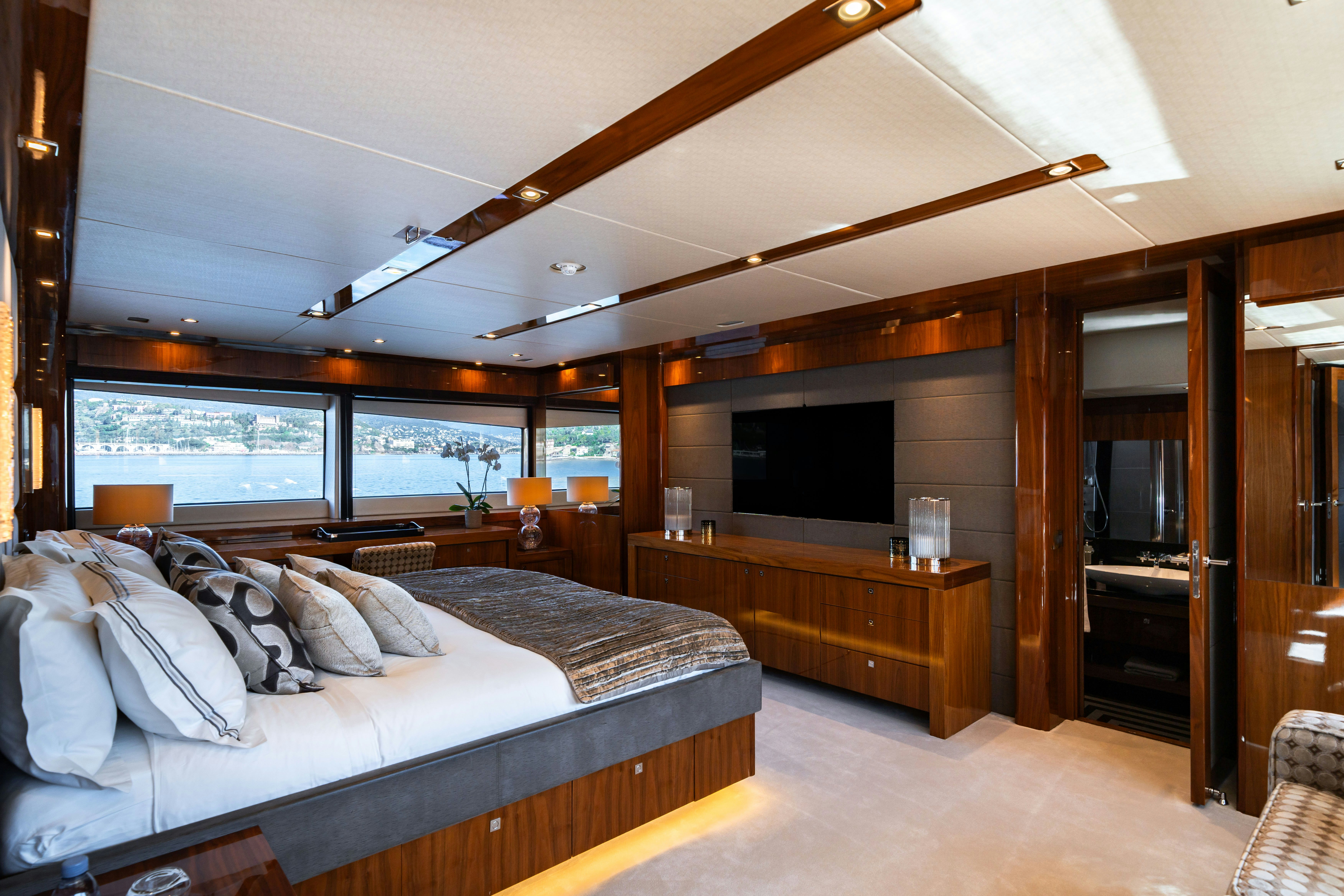 a bedroom with a large bed aboard LADY VOLANTIS Yacht for Sale
