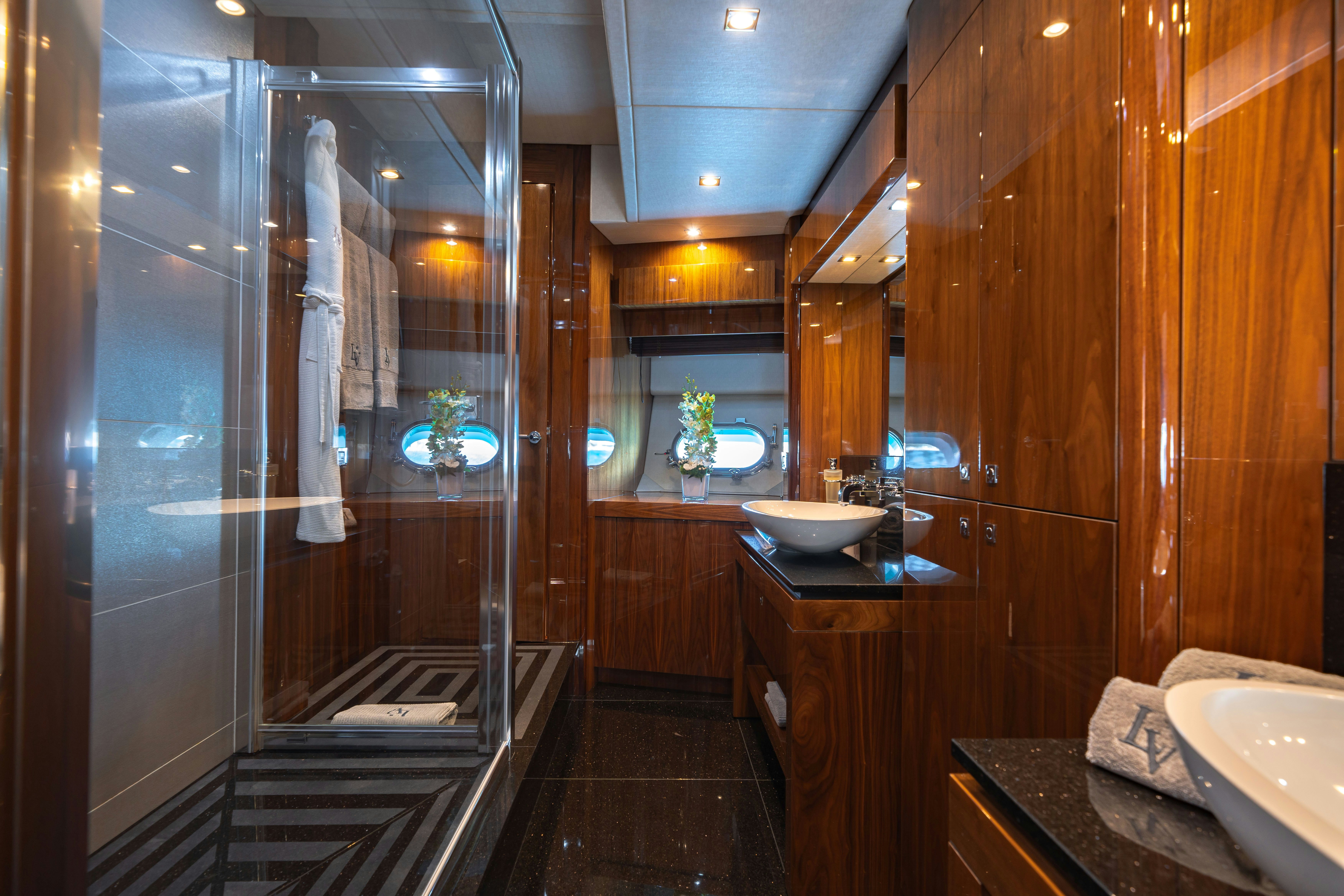 a bathroom with a glass shower aboard LADY VOLANTIS Yacht for Sale