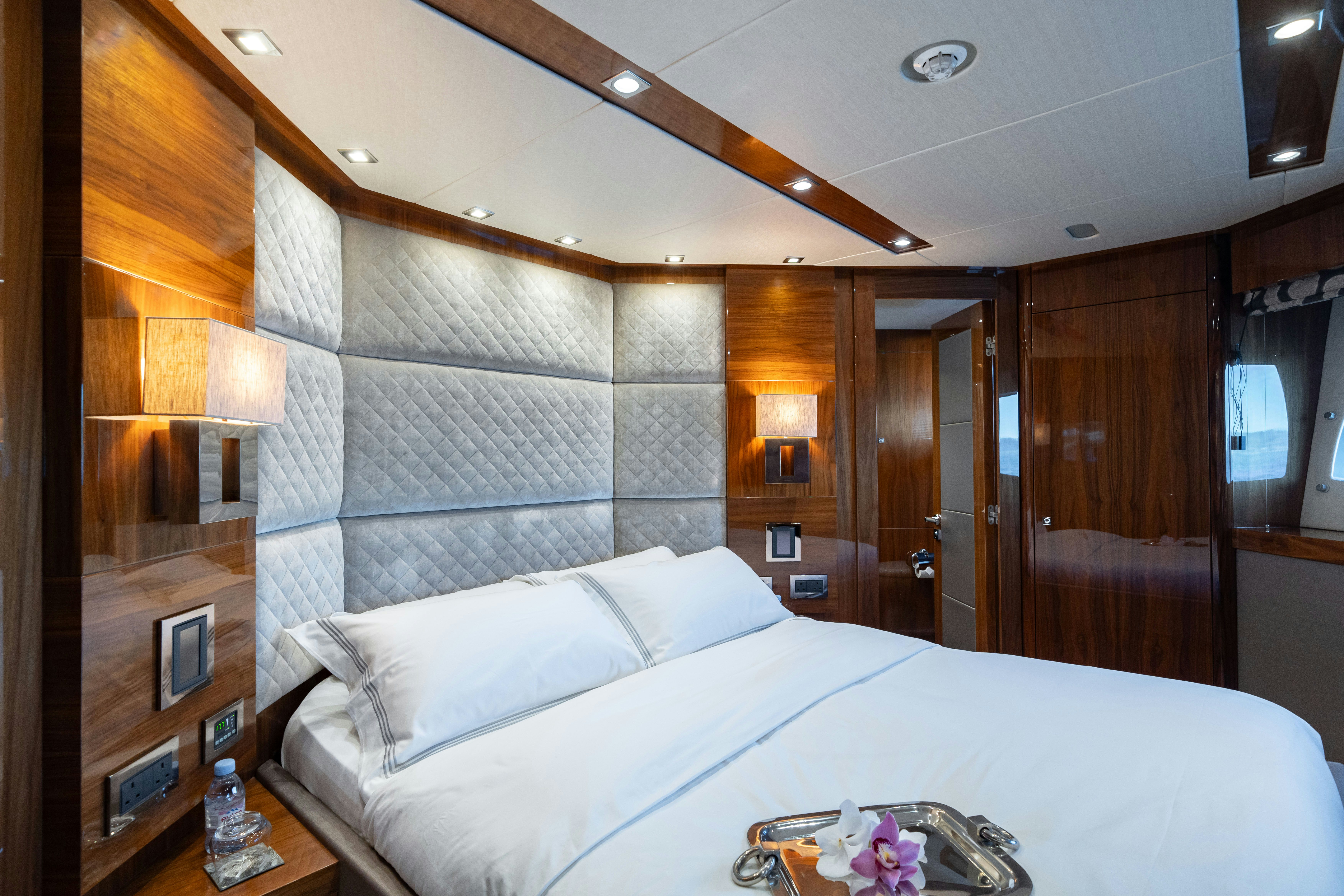 a bedroom with a bed and a mirror aboard LADY VOLANTIS Yacht for Sale