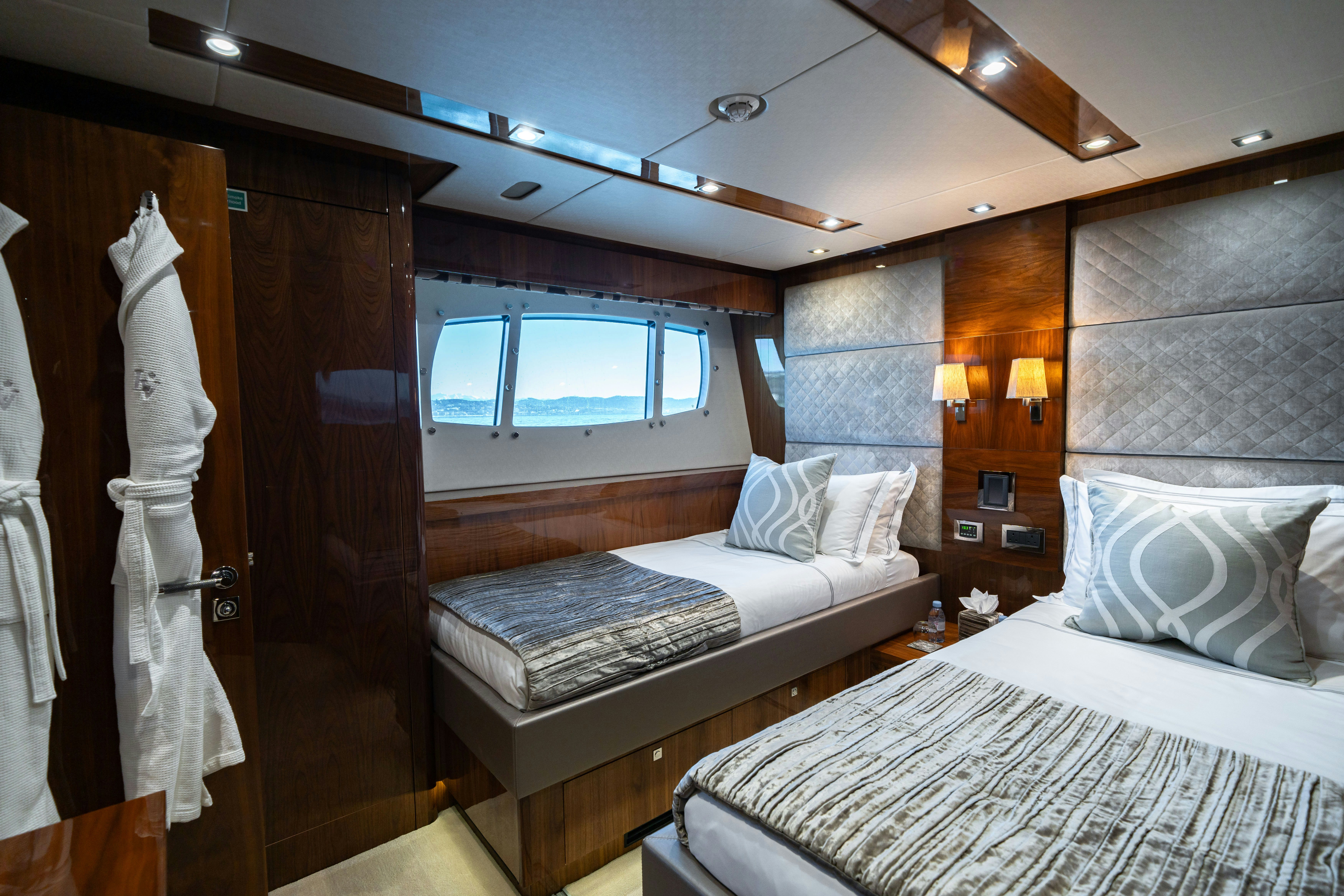 a room with a bed and a mirror aboard LADY VOLANTIS Yacht for Sale