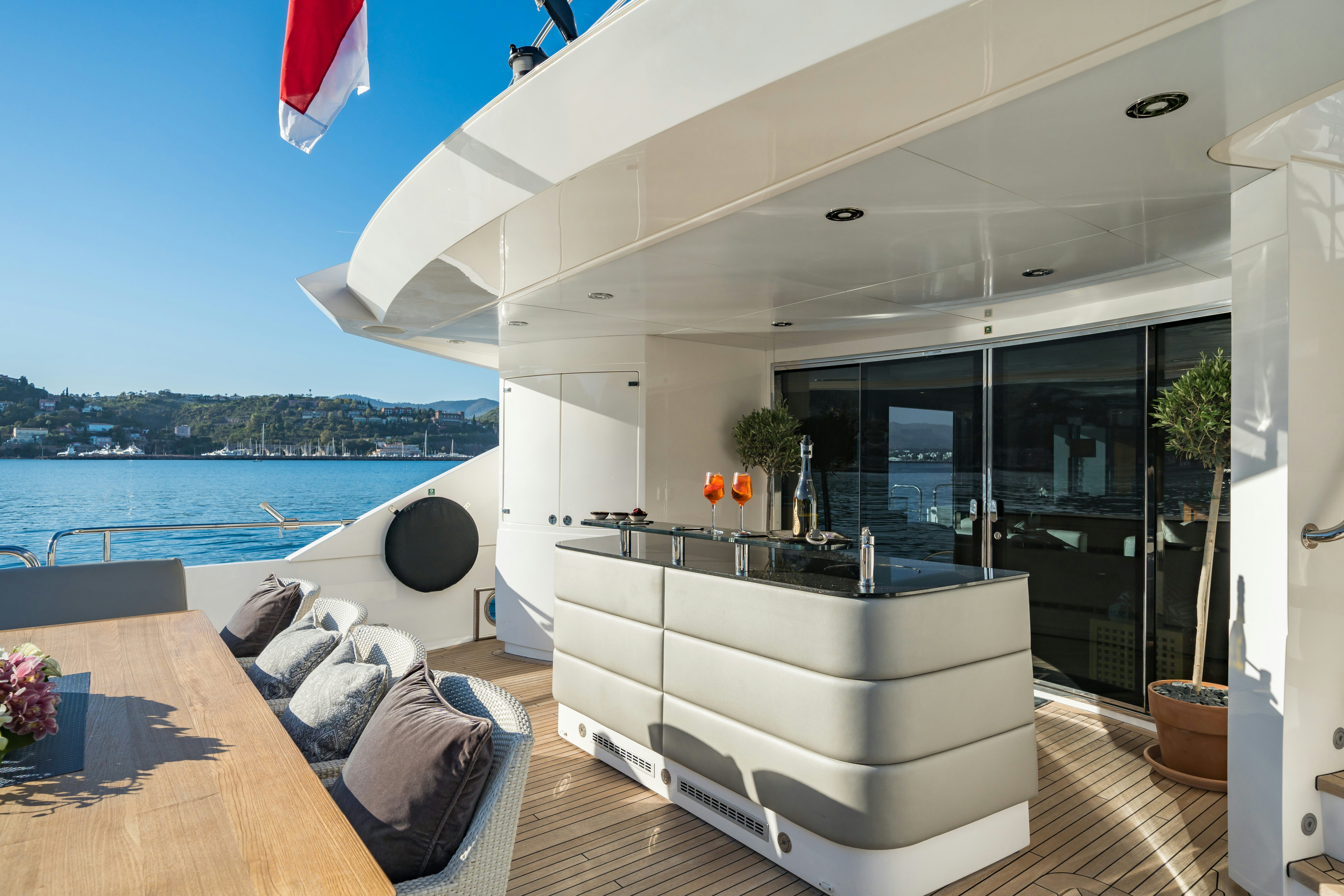 a living room with a large glass door and a balcony aboard LADY VOLANTIS Yacht for Sale