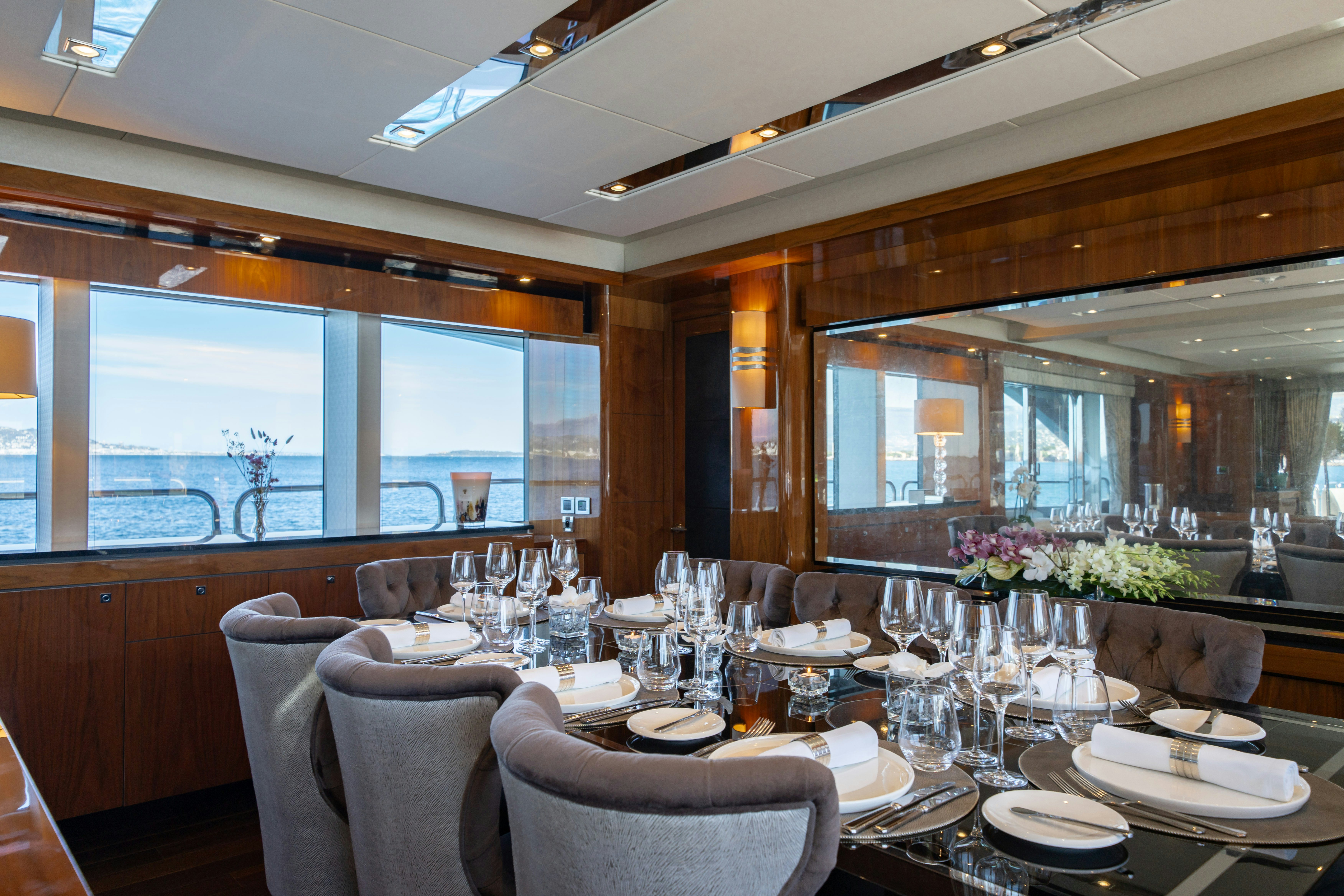 a large dining room with a large window aboard LADY VOLANTIS Yacht for Sale