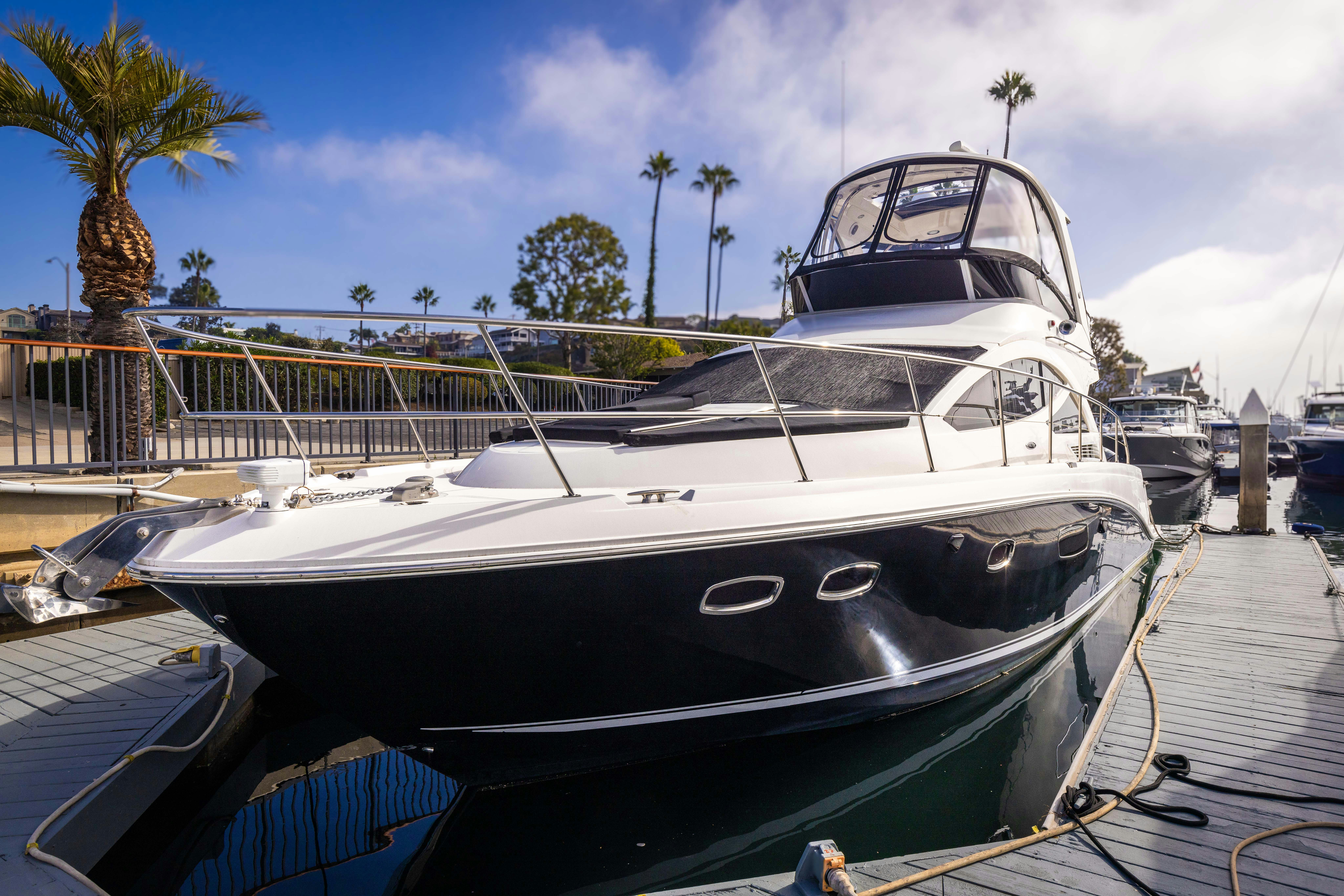 a large boat docked at a pier aboard KA-BAR Yacht for Sale