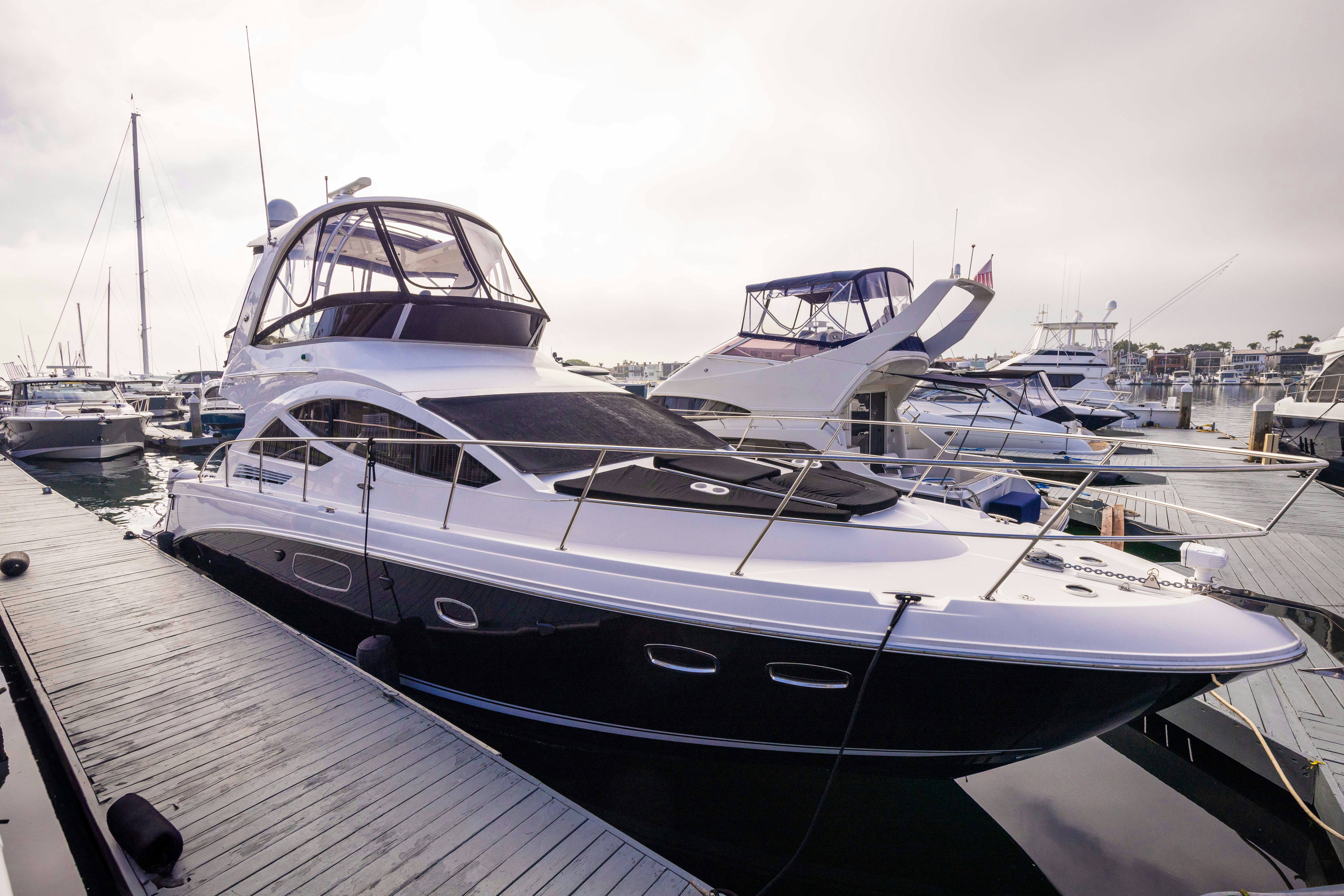 a yacht docked at a pier aboard KA-BAR Yacht for Sale