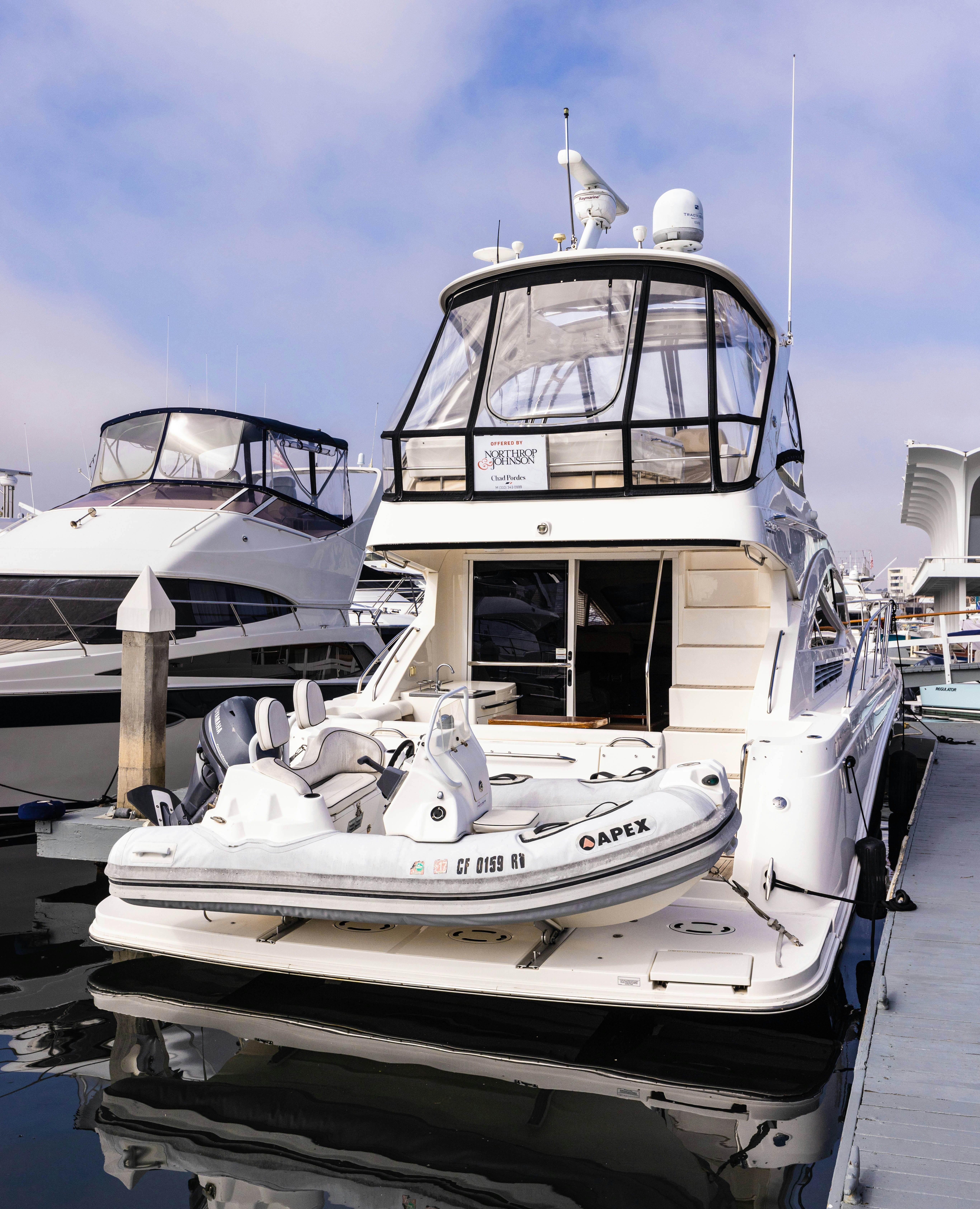 a large white boat in a harbor aboard KA-BAR Yacht for Sale