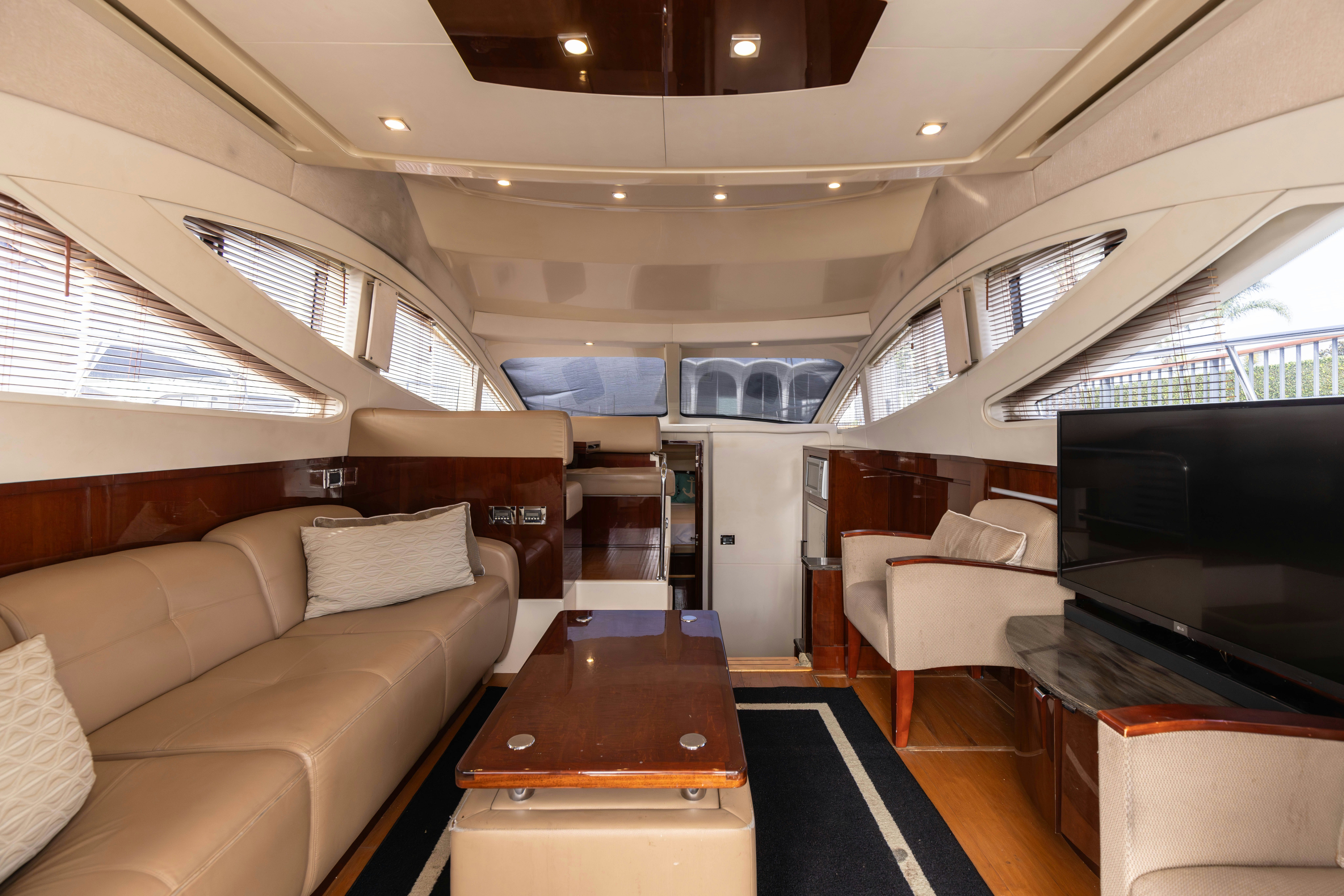 a living room with a couch and a tv aboard KA-BAR Yacht for Sale