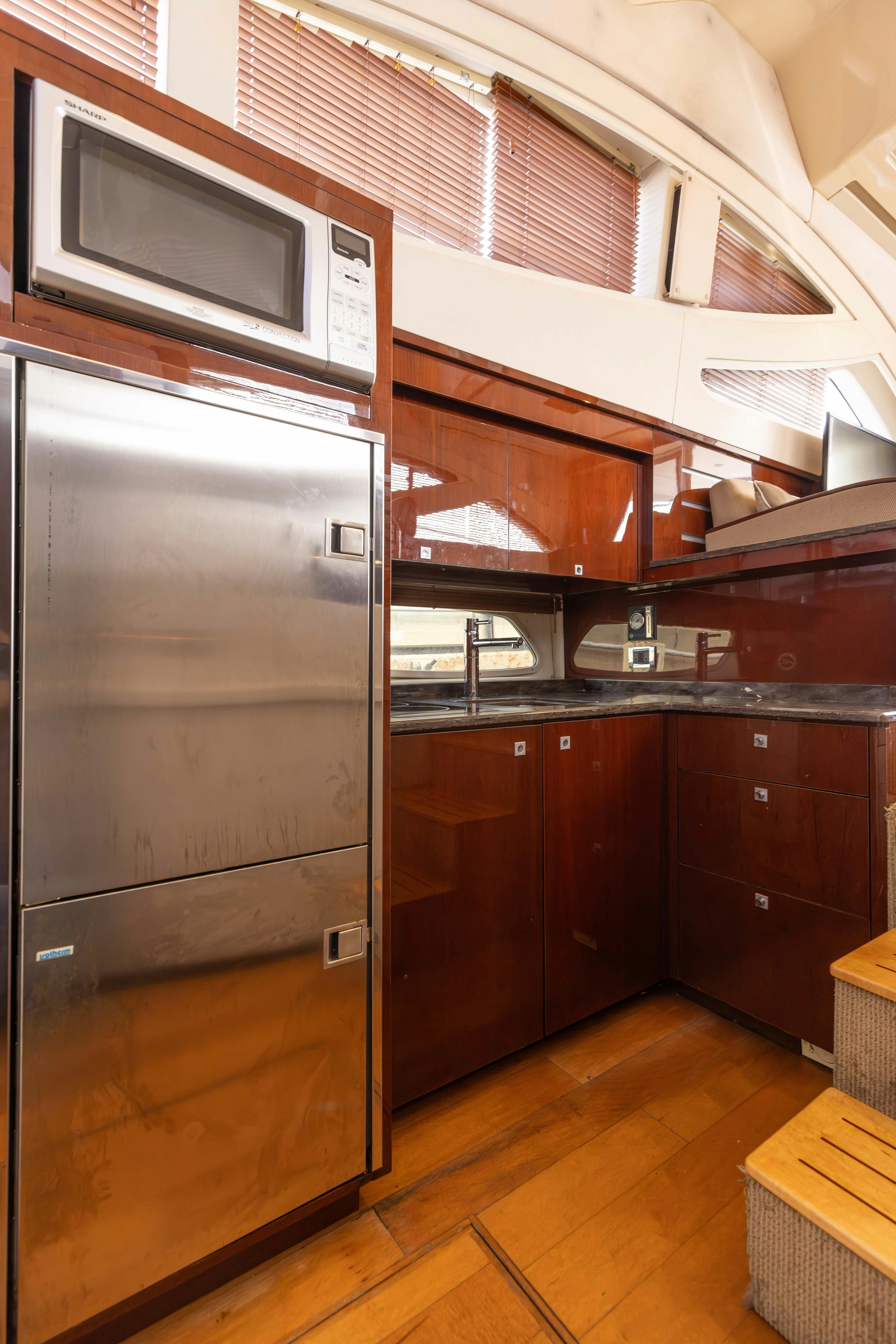a kitchen with wooden cabinets aboard KA-BAR Yacht for Sale