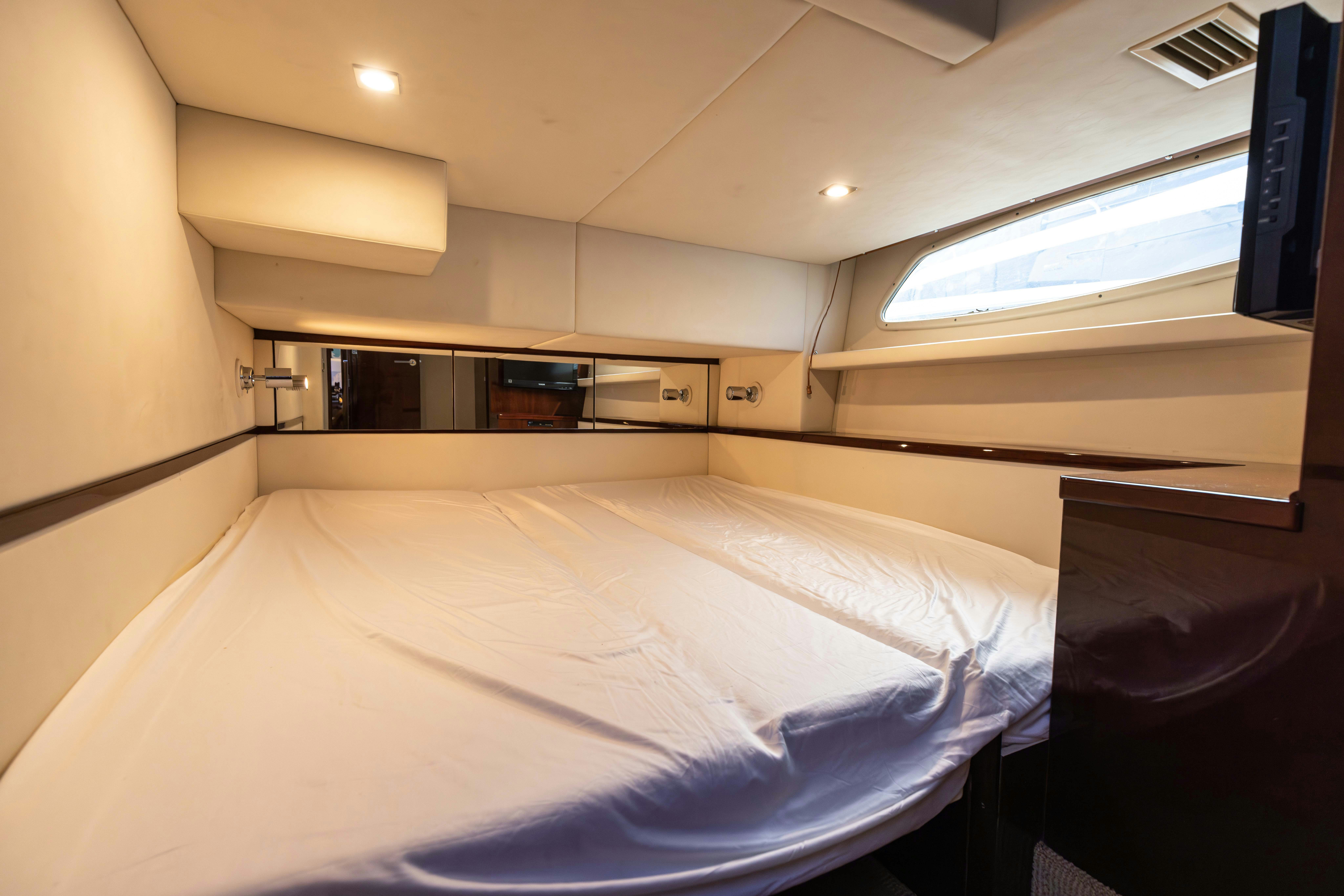a room with a bed and a window aboard KA-BAR Yacht for Sale