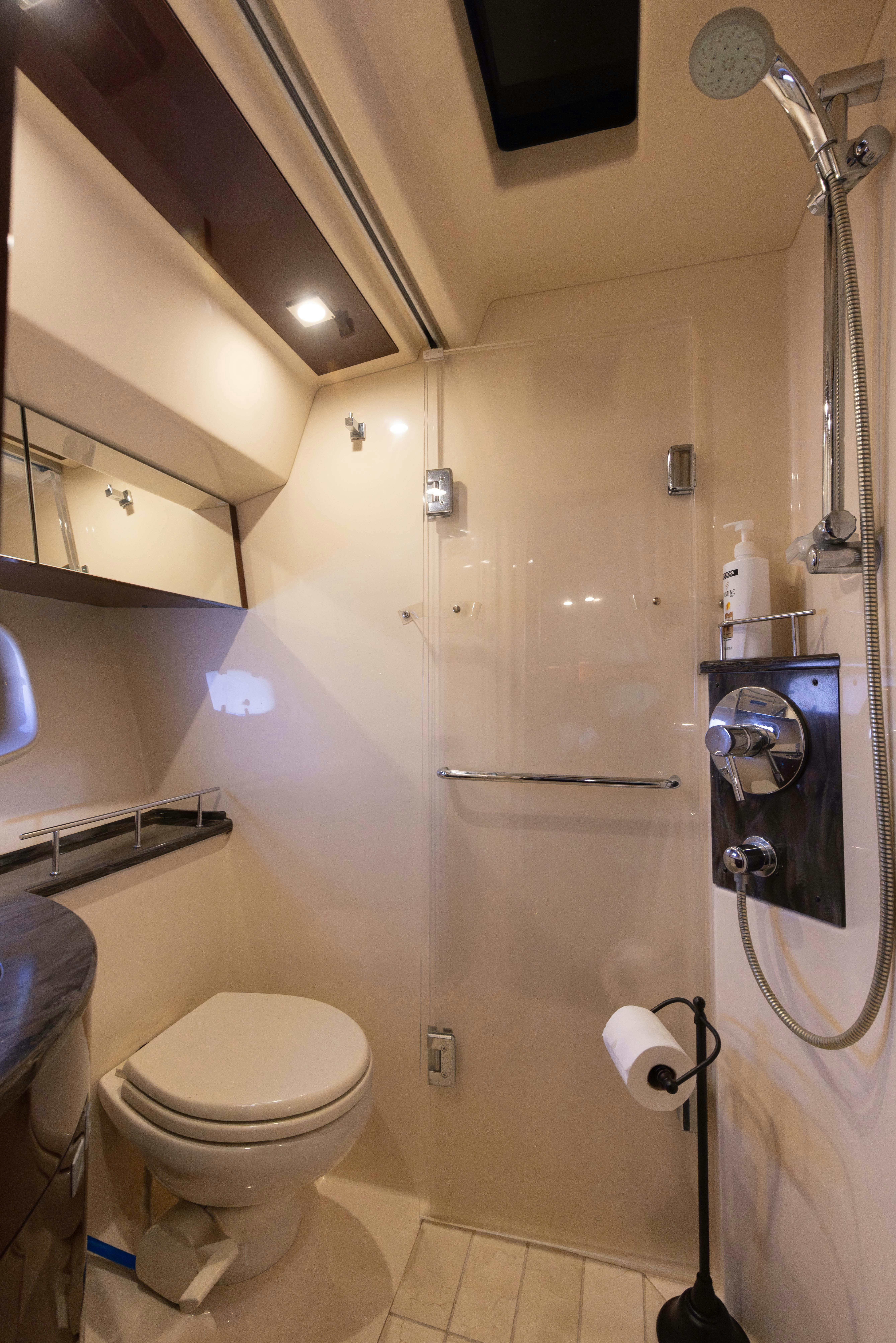 a bathroom with a toilet and a shower aboard KA-BAR Yacht for Sale