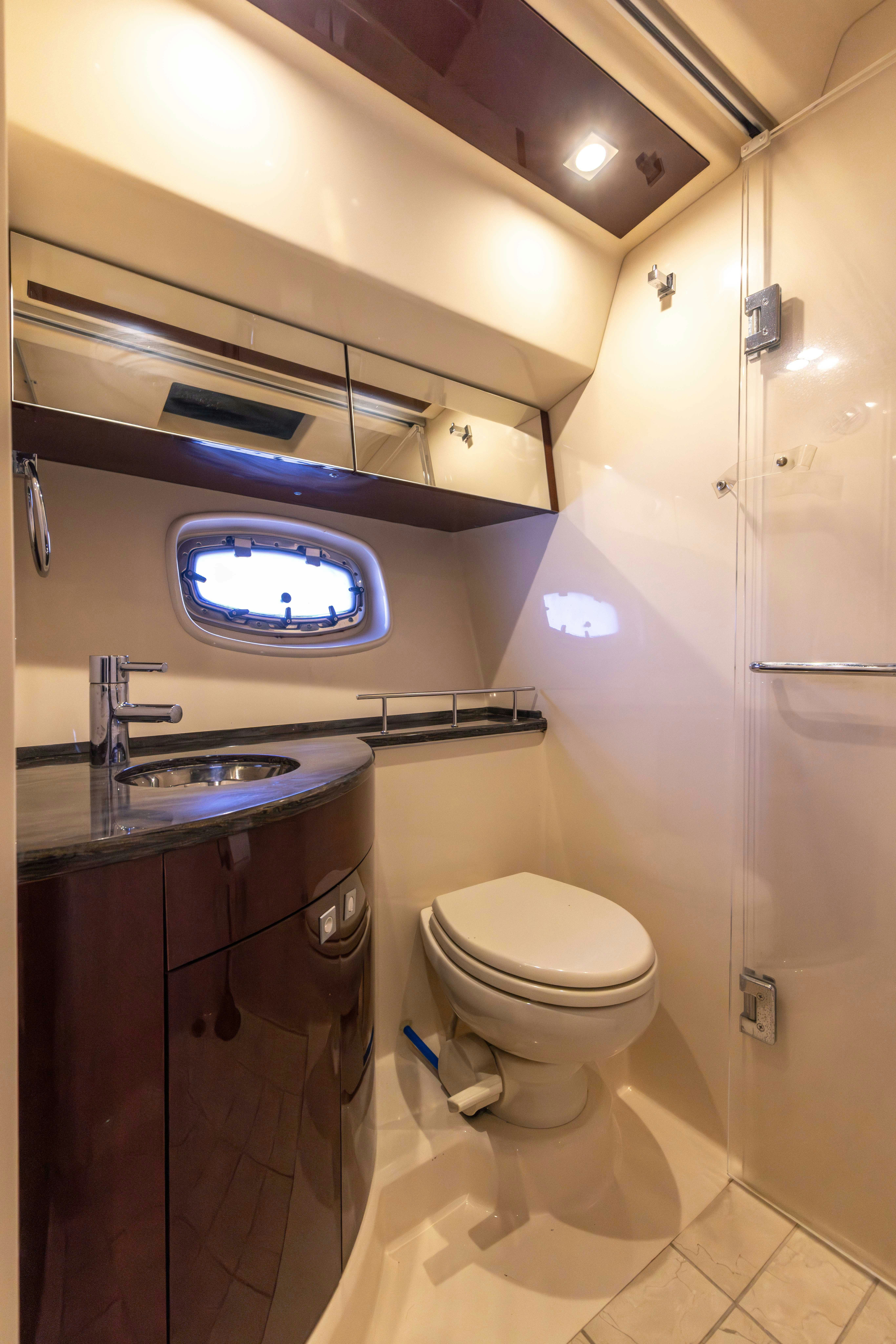 a bathroom with a glass shower aboard KA-BAR Yacht for Sale