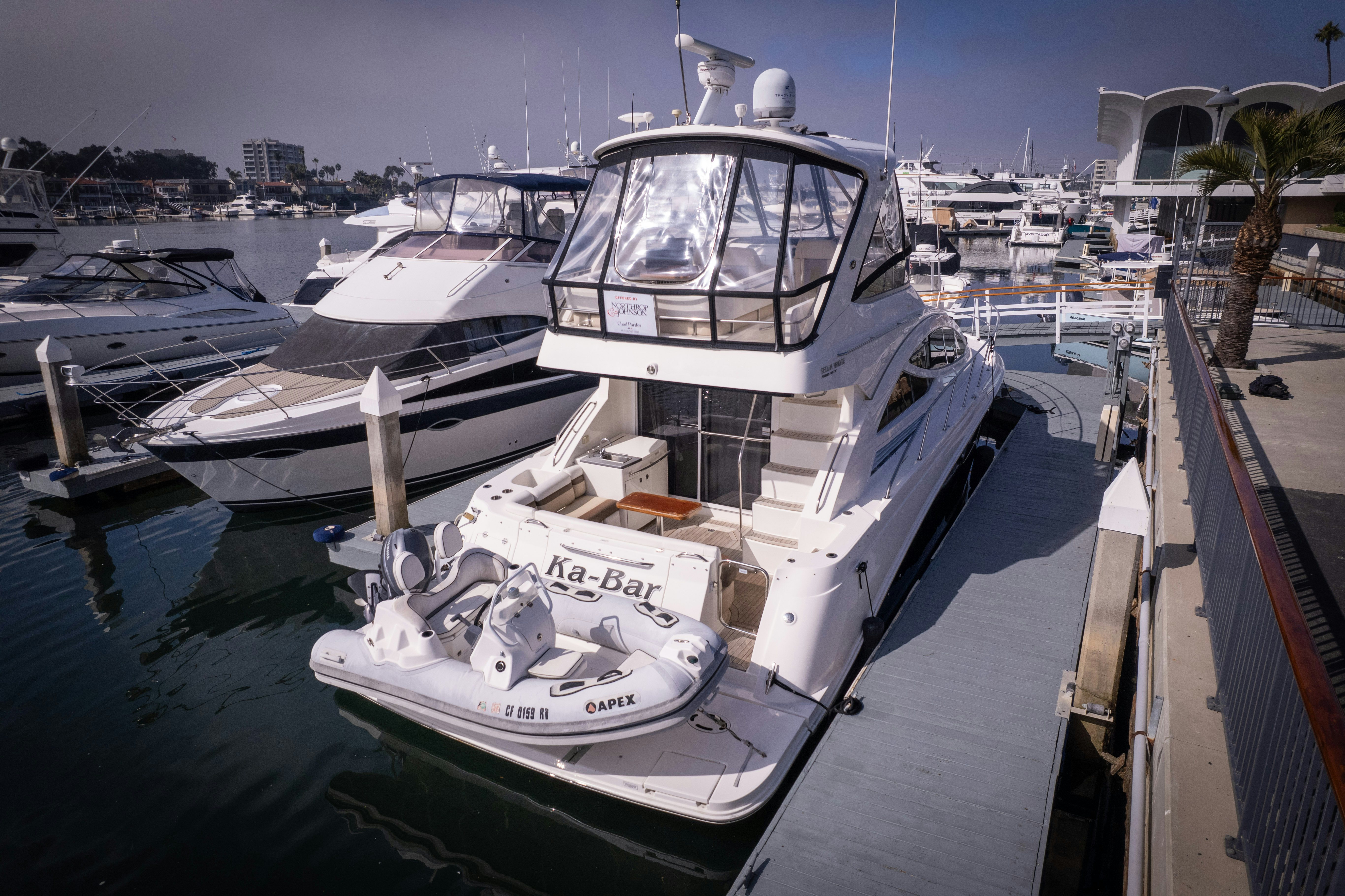 a boat docked at a pier aboard KA-BAR Yacht for Sale